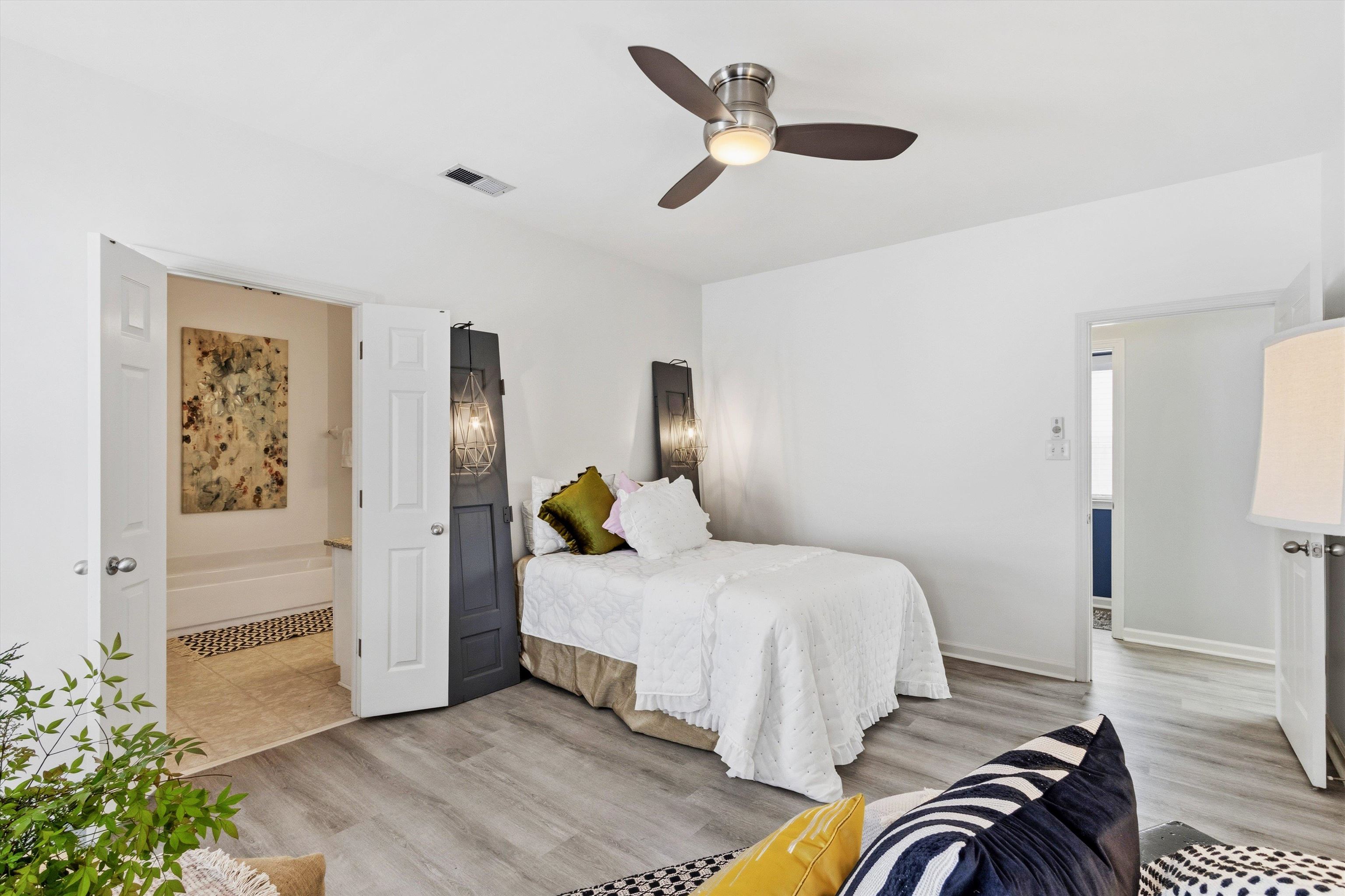 1182 Isle View Drive Memphis, TN 38103 - Photo 14 of 27 a bedroom with a bed and a chandelier