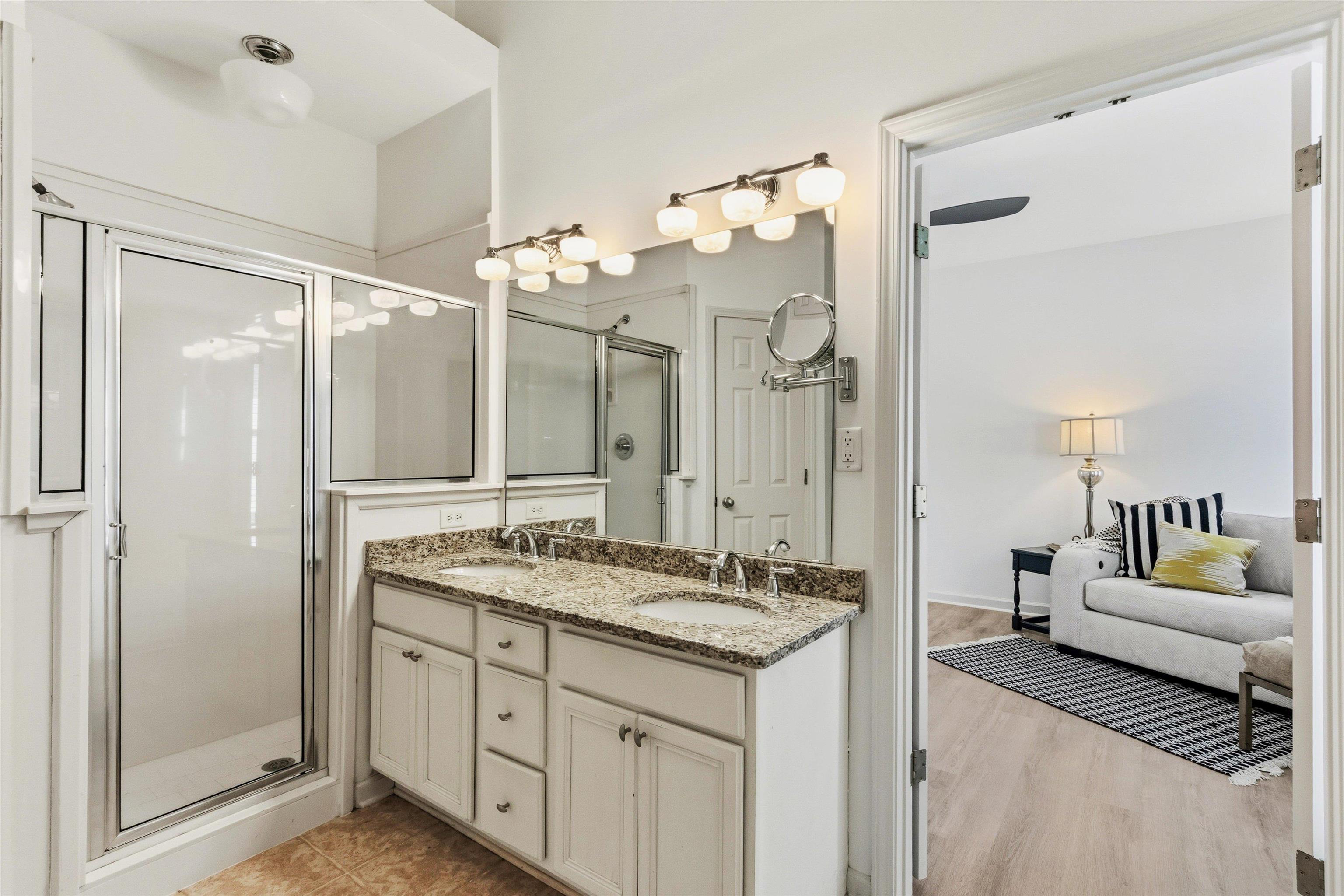 1182 Isle View Drive Memphis, TN 38103 - Photo 16 of 27 a spacious bathroom with a granite countertop sink mirror and a shower