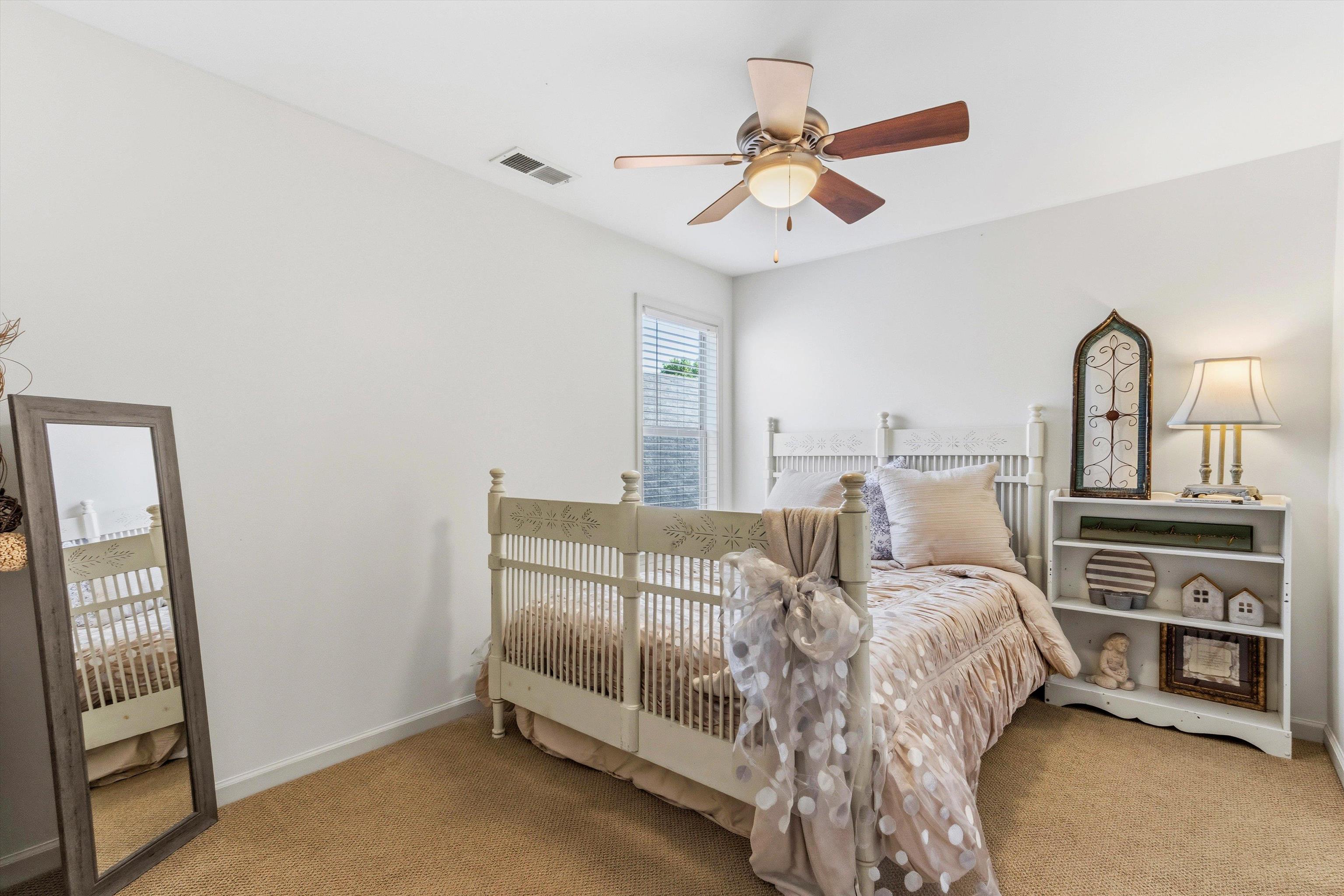 1182 Isle View Drive Memphis, TN 38103 - Photo 17 of 27 a bed room with a bed and a ceiling fan