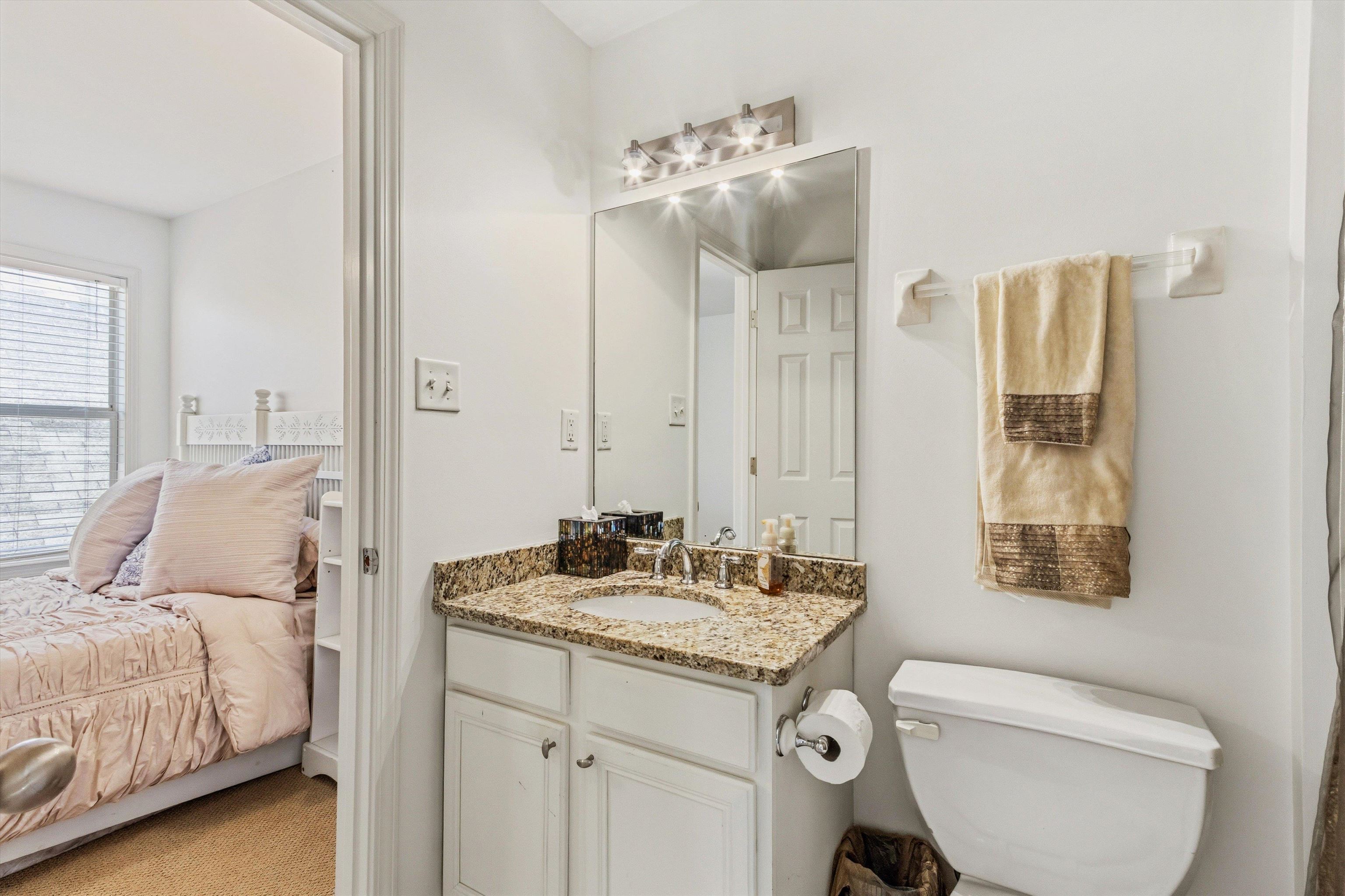 1182 Isle View Drive Memphis, TN 38103 - Photo 19 of 27 a en suite bathroom with a granite countertop sink and a mirror