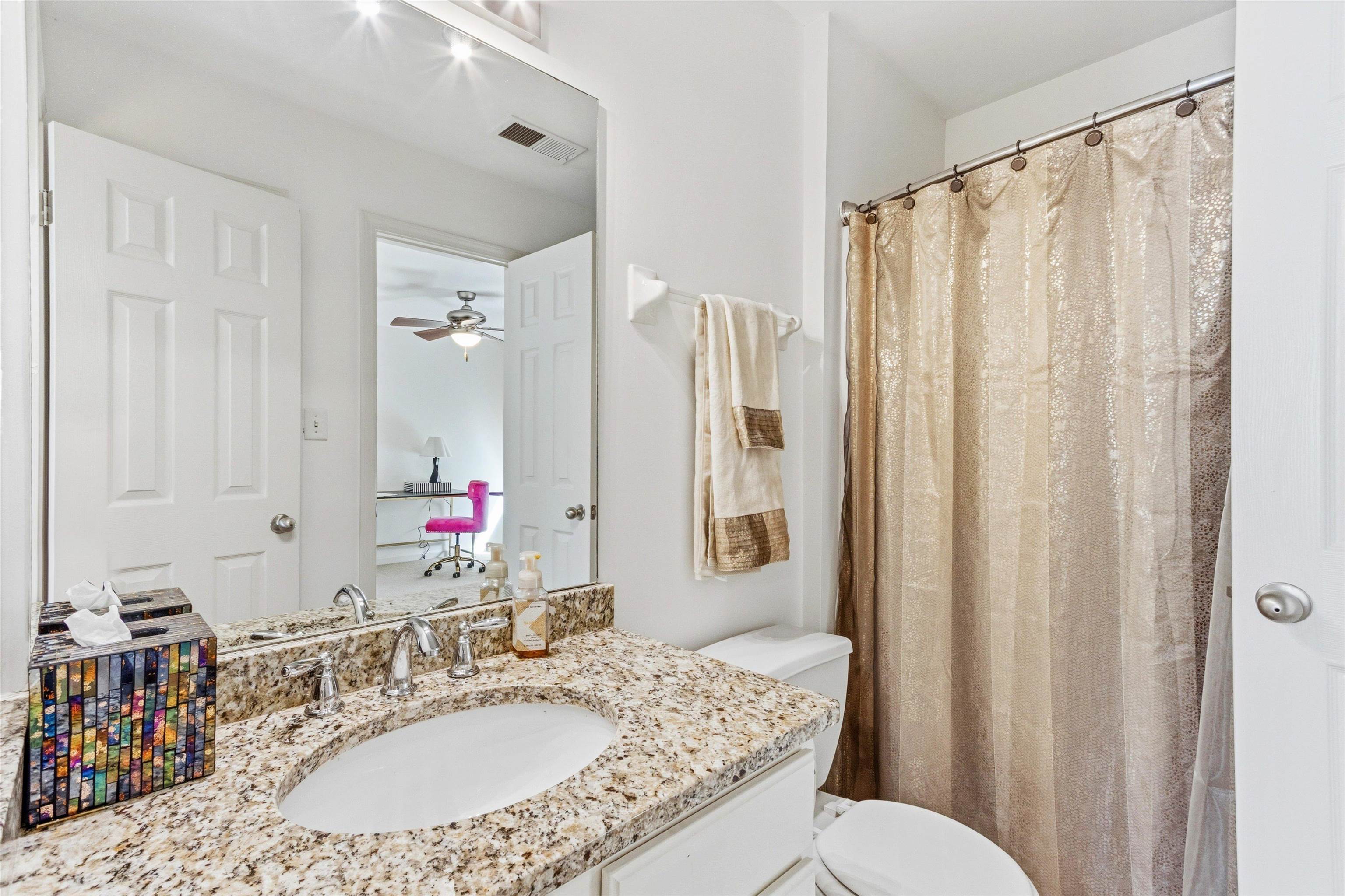 1182 Isle View Drive Memphis, TN 38103 - Photo 20 of 27 a bathroom with a granite countertop sink toilet and shower