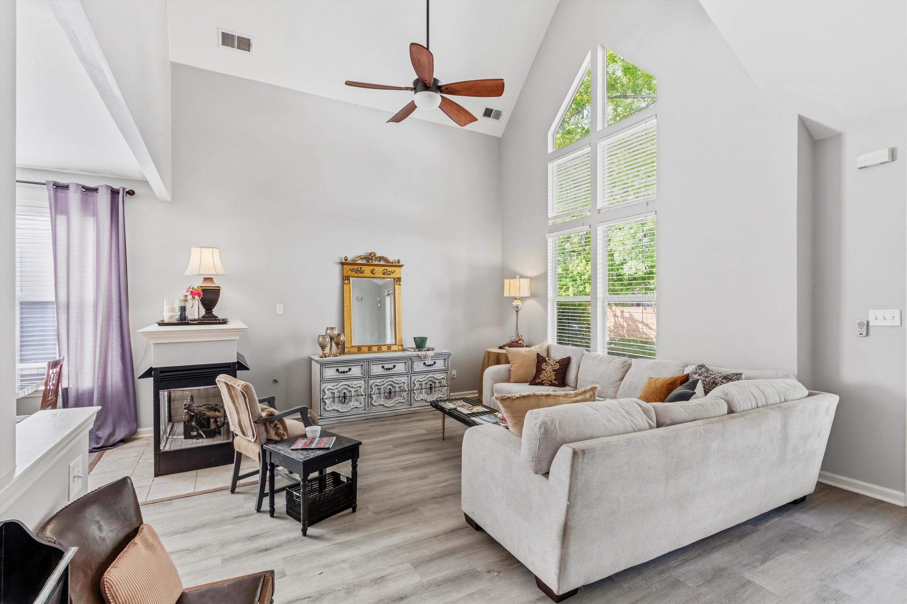 1182 Isle View Drive Memphis, TN 38103 - Photo 5 of 27 a living room with furniture fireplace and a large window