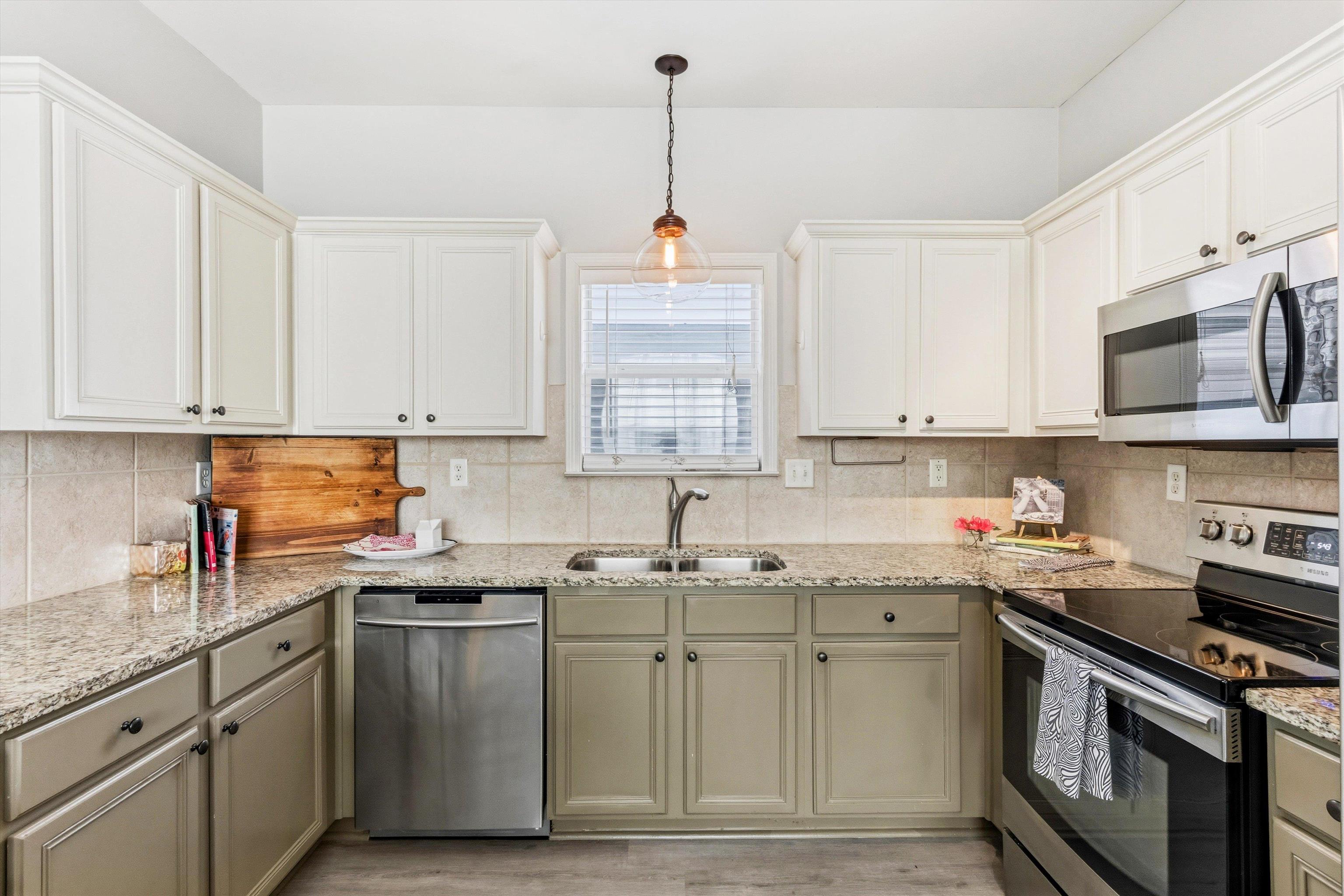 1182 Isle View Drive Memphis, TN 38103 - Photo 10 of 27 a kitchen with stainless steel appliances granite countertop a sink dishwasher a stove and a microwave oven with cabinets