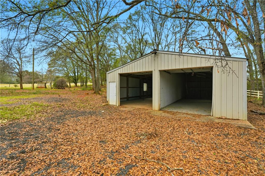 1295 Double Bridges Road Winder, GA 30680 - Photo 40 of 57 a front view of a house with a yard and garage