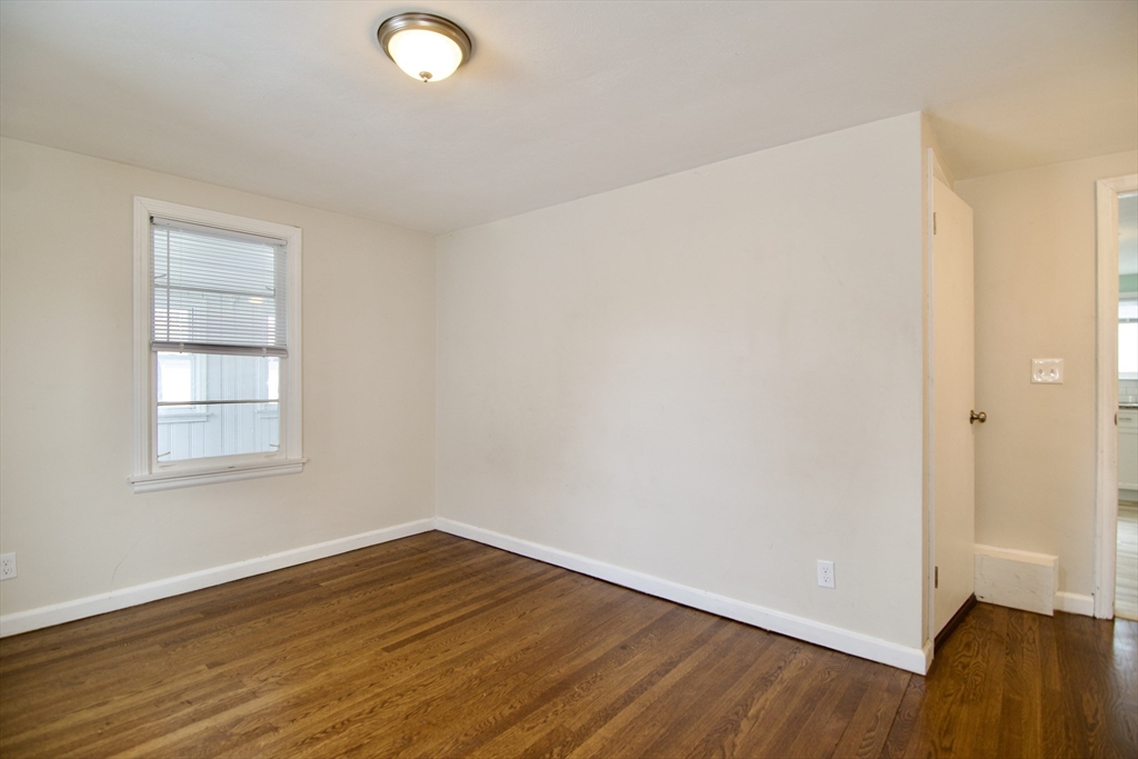 49 Rimmon Avenue Springfield, MA 01107 - Photo 25 of 32 an empty room with wooden floor and windows