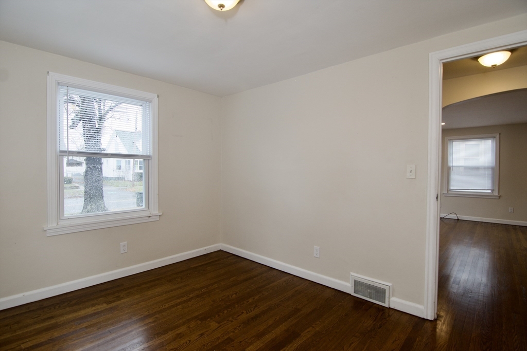 49 Rimmon Avenue Springfield, MA 01107 - Photo 29 of 32 an empty room with wooden floor and windows