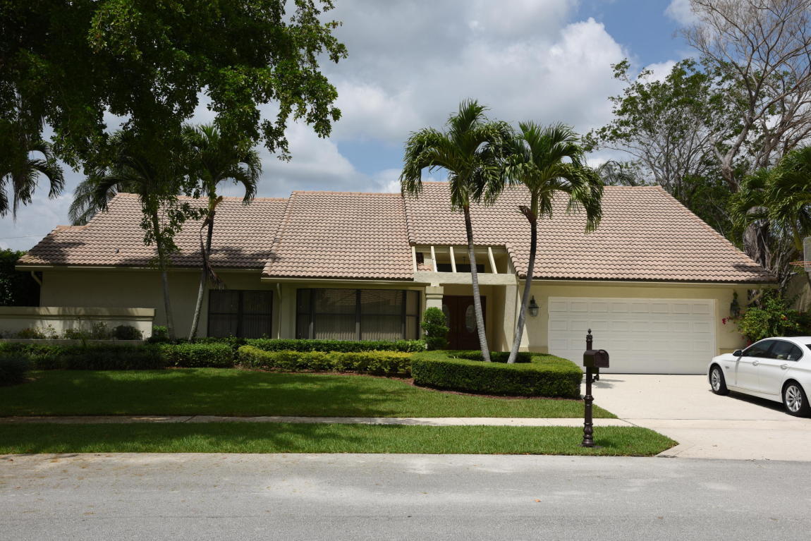 4465 Northwest 28th Way Boca Raton, FL 33434 - Photo 1 of 22 a front view of a house with a garden