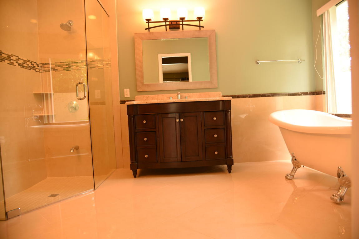4465 Northwest 28th Way Boca Raton, FL 33434 - Photo 12 of 22 a bathroom with a granite countertop sink and a mirror