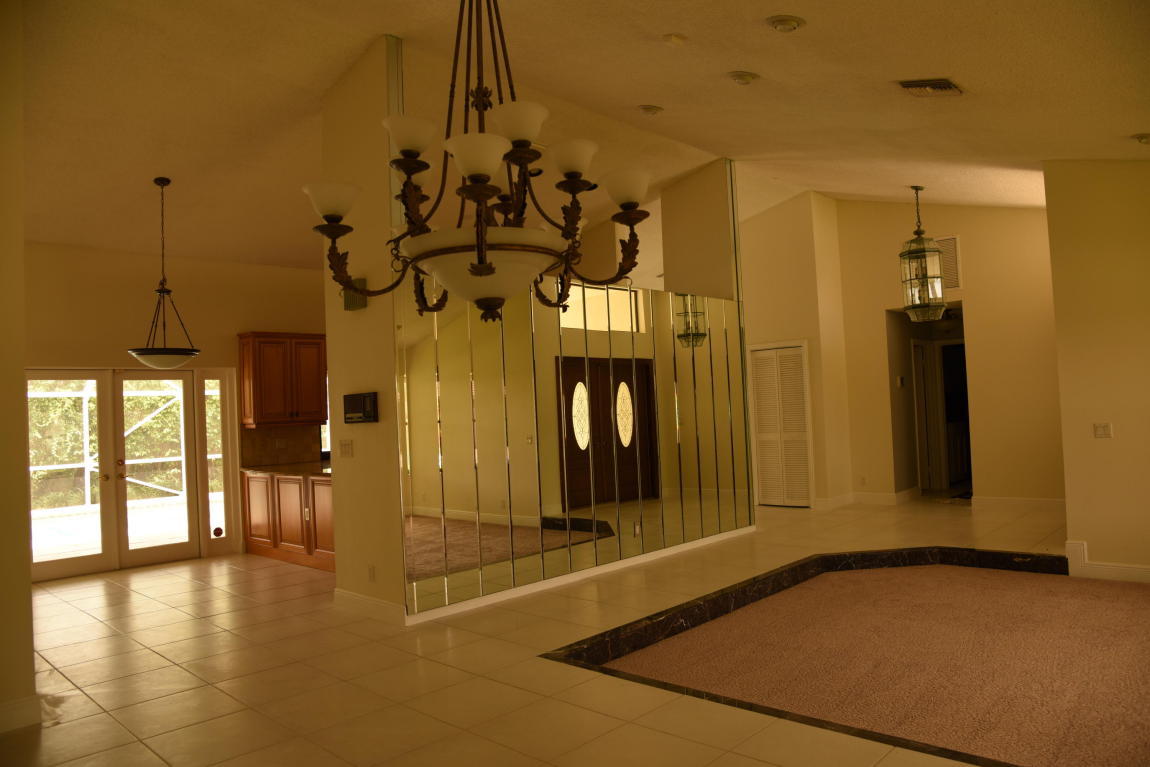 4465 Northwest 28th Way Boca Raton, FL 33434 - Photo 13 of 22 a view of a hallway with a chandelier