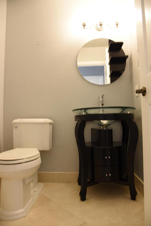 4465 Northwest 28th Way Boca Raton, FL 33434 - Photo 15 of 22 a bathroom with a toilet and a mirror