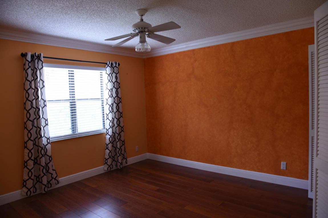4465 Northwest 28th Way Boca Raton, FL 33434 - Photo 17 of 22 a view of empty room with wooden floor and fan