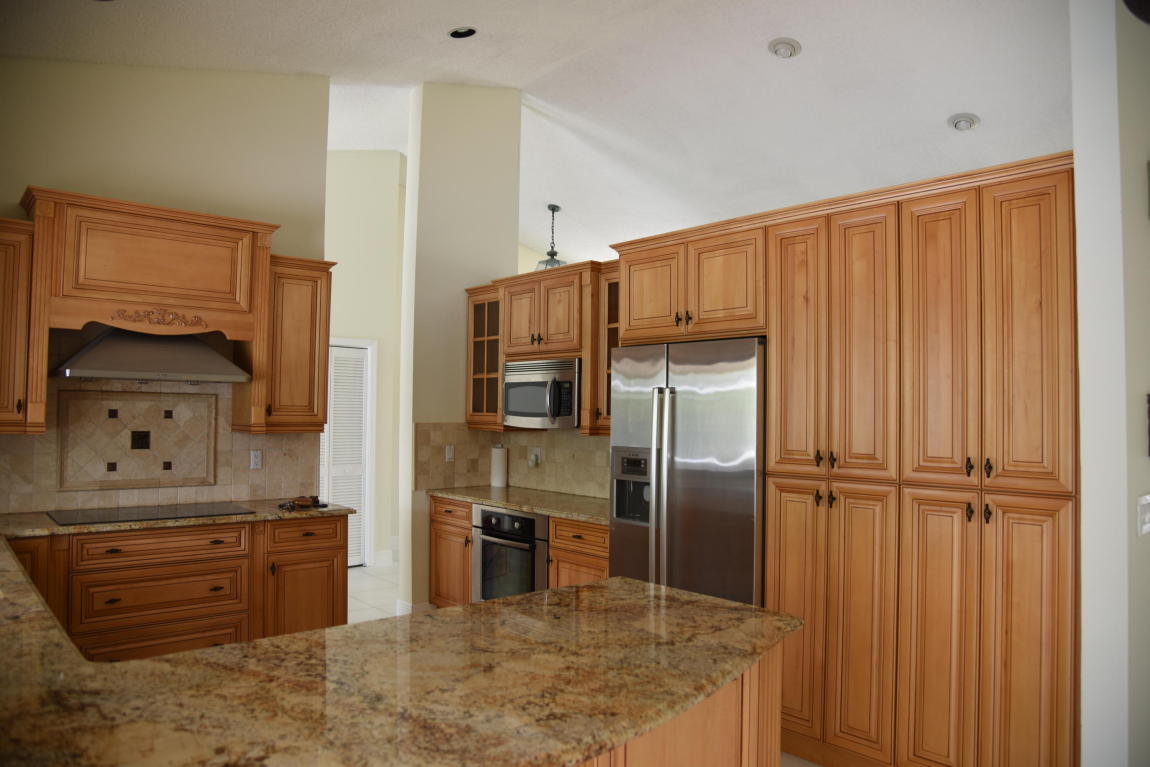 4465 Northwest 28th Way Boca Raton, FL 33434 - Photo 4 of 22 a kitchen with stainless steel appliances granite countertop a refrigerator and a sink