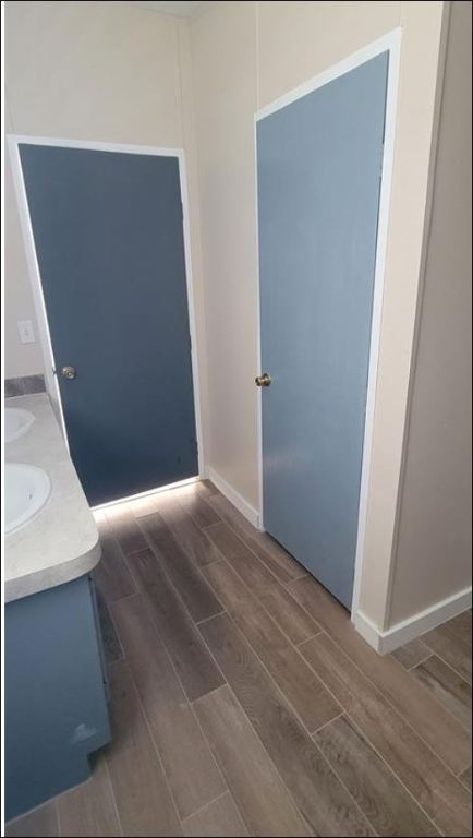 404 West Cleveland Street, Unit 1/2 Elgin, TX 78621 - Photo 17 of 23 Bathroom with wood finish floors and double vanity