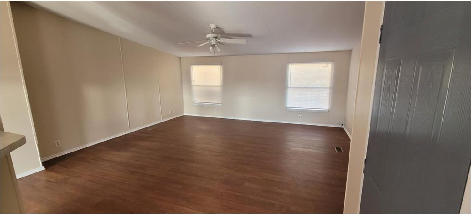 404 West Cleveland Street, Unit 1/2 Elgin, TX 78621 - Photo 21 of 23 Unfurnished room with dark wood finished floors and ceiling fan
