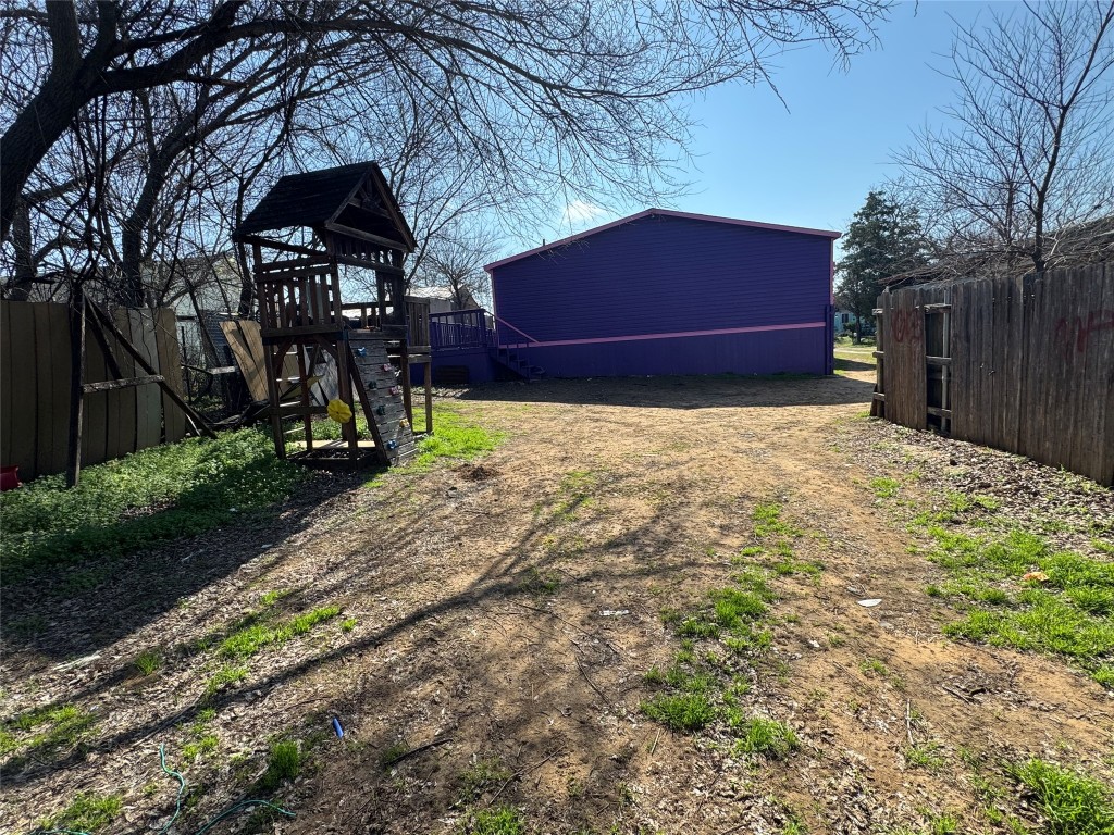 404 West Cleveland Street, Unit 1/2 Elgin, TX 78621 - Photo 5 of 23 View of yard with a deck and a playground