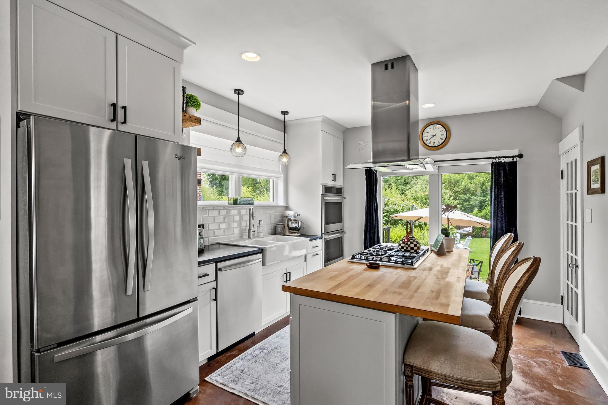 239 James Street Mount Ephraim, NJ 08059 - Photo 11 of 39 a kitchen with stainless steel appliances a refrigerator a table and chairs in it