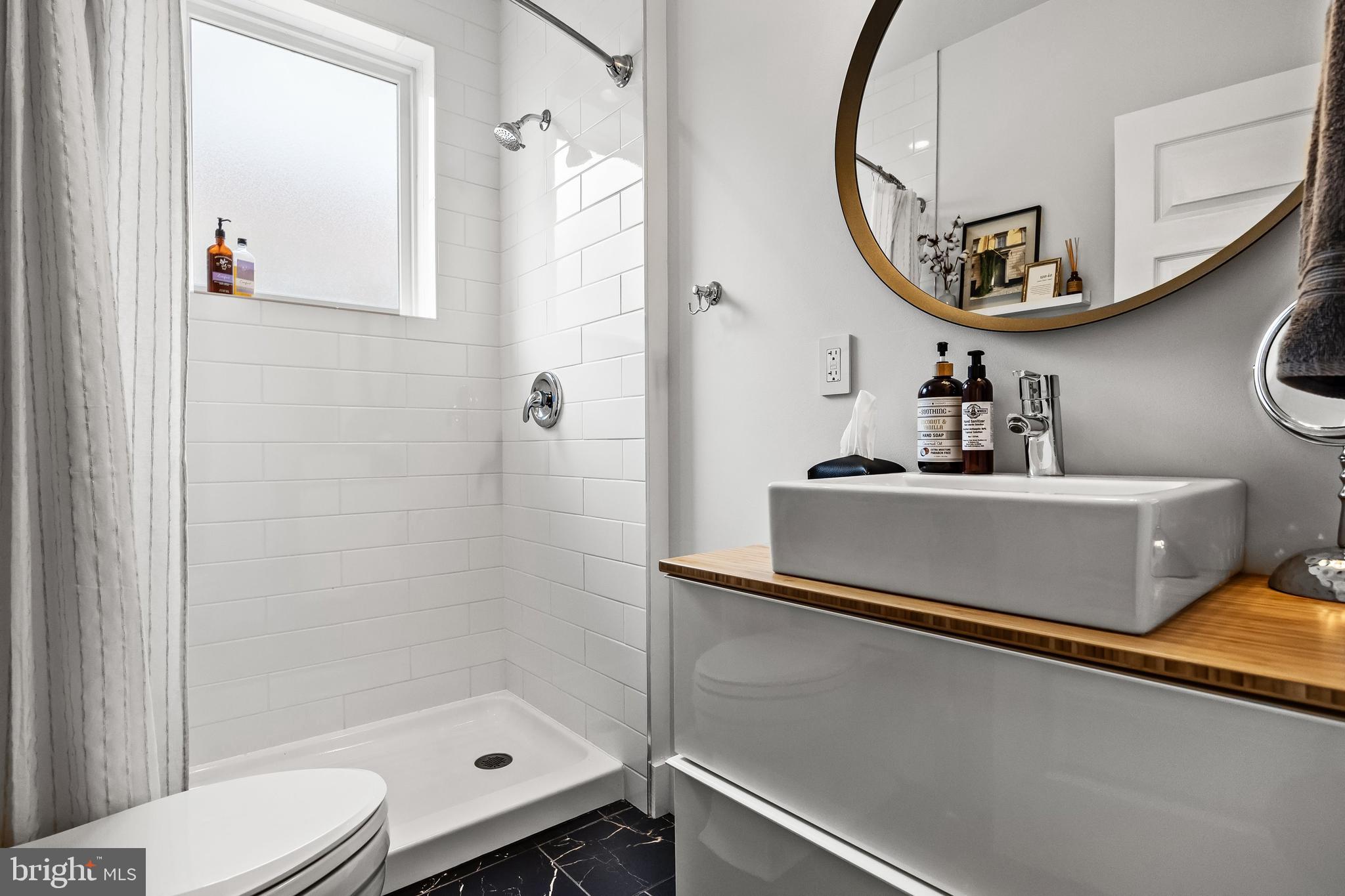 239 James Street Mount Ephraim, NJ 08059 - Photo 17 of 39 a bathroom with a sink a mirror and a shower