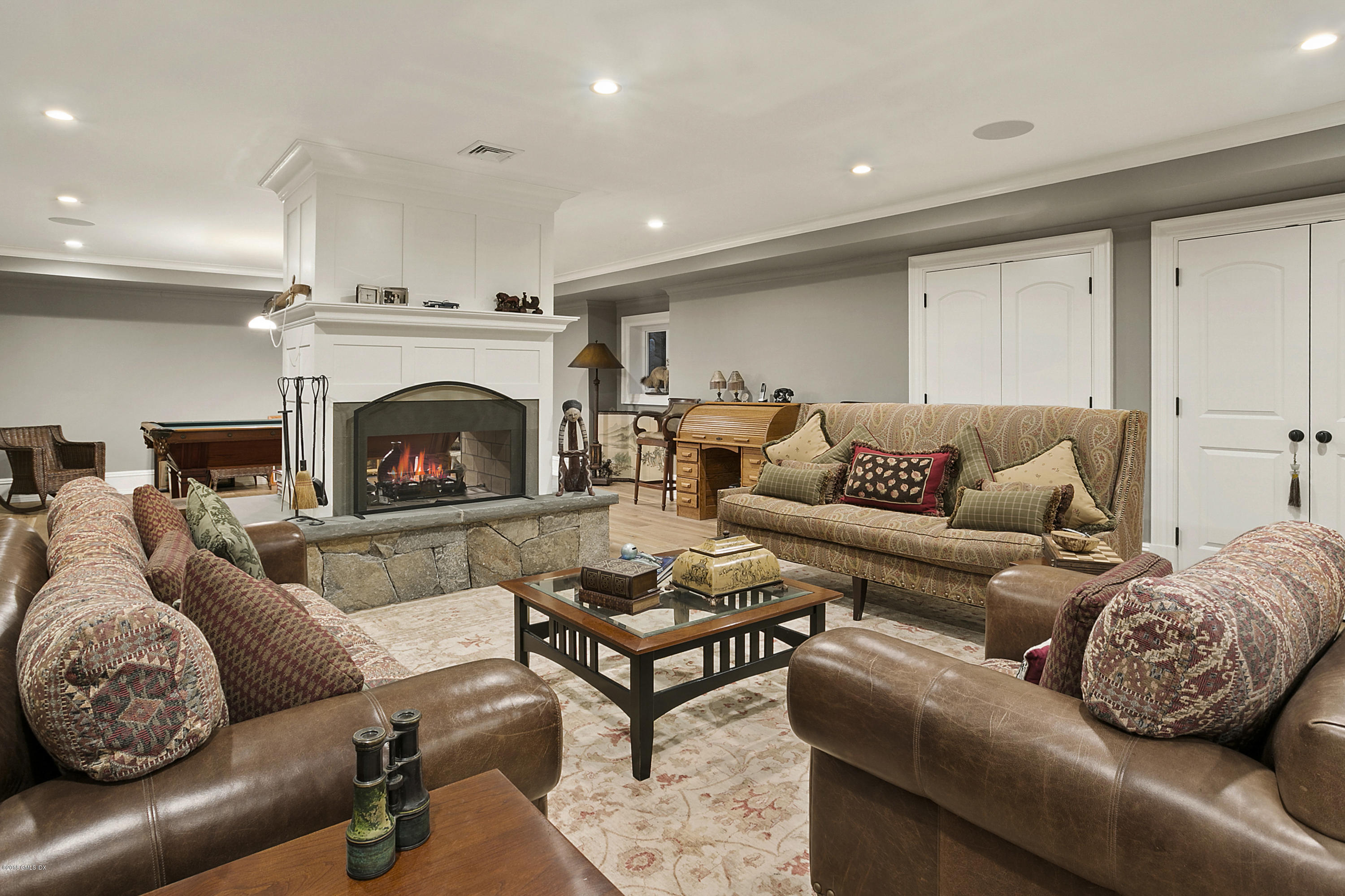 80 Howard Road Greenwich, CT 06831 - Photo 25 of 32 a living room with furniture a rug and a fireplace