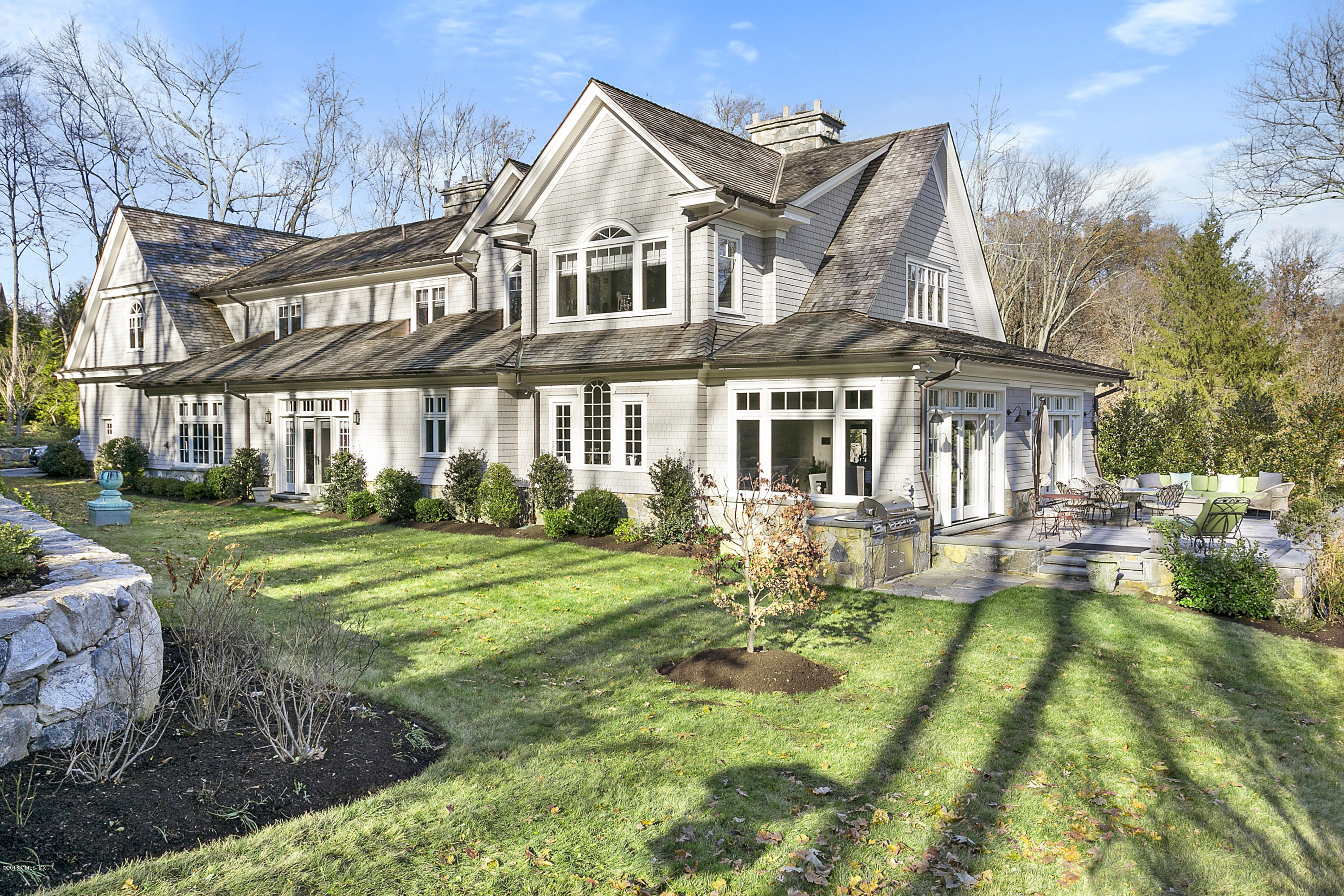 80 Howard Road Greenwich, CT 06831 - Photo 32 of 32 a front view of a house with a yard table and chairs