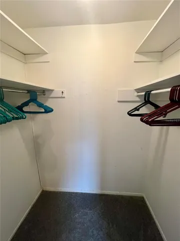 a bathroom with a sink a toilet a mirror a vanity and window