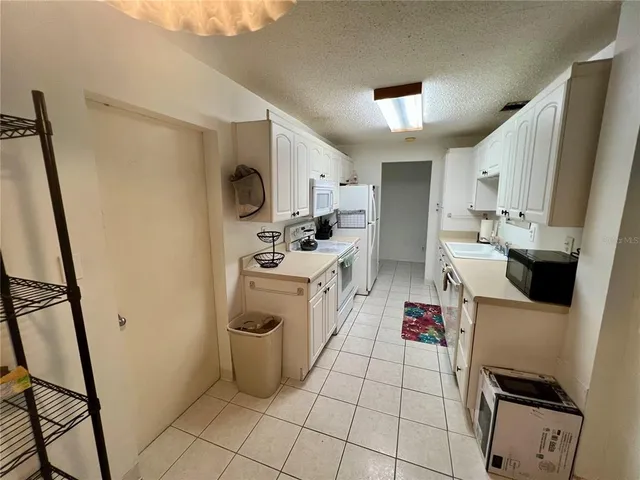 a kitchen with a sink a stove top oven and cabinets