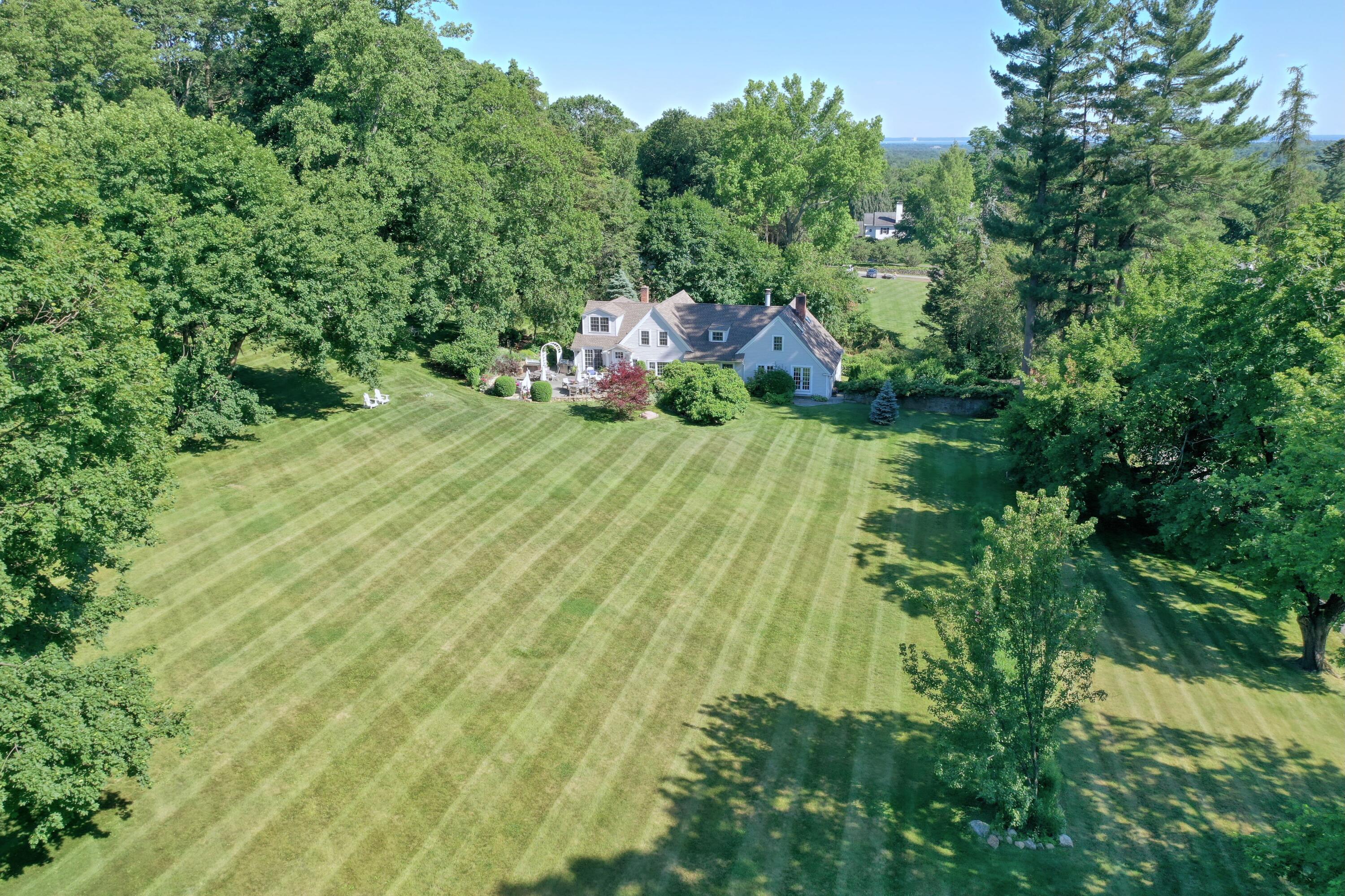 203 Brushy Ridge Road New Canaan, CT 06840 - Photo 1 of 42 an aerial view of a house with a yard basket ball court and outdoor seating