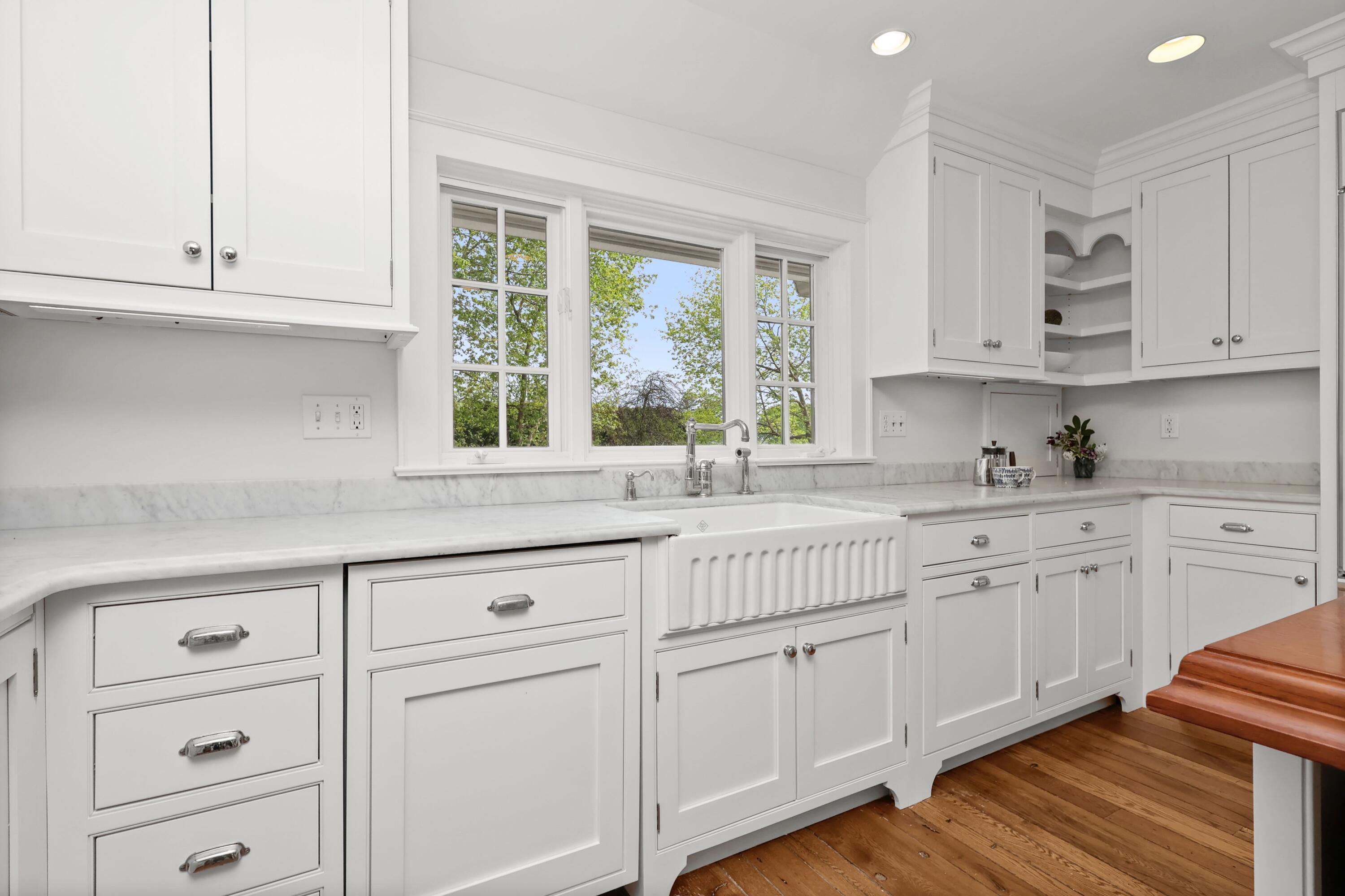 203 Brushy Ridge Road New Canaan, CT 06840 - Photo 14 of 42 a kitchen with granite countertop white cabinets and white appliances
