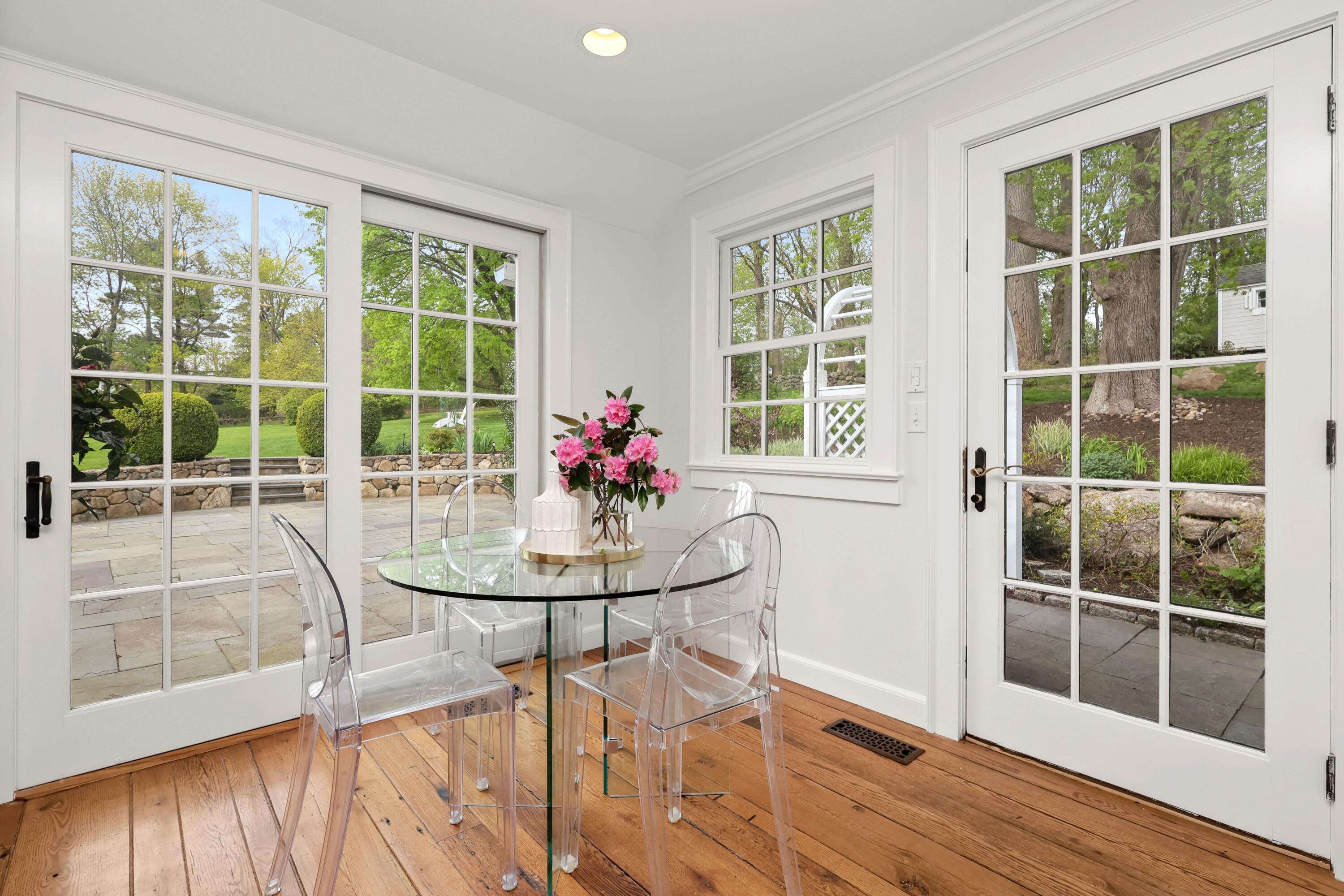 203 Brushy Ridge Road New Canaan, CT 06840 - Photo 16 of 42 a view of a dining room with furniture window and wooden floor