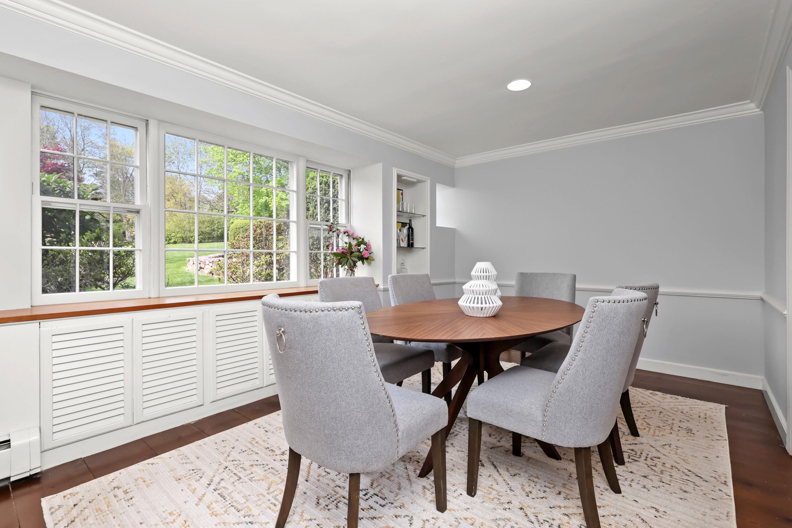 203 Brushy Ridge Road New Canaan, CT 06840 - Photo 24 of 42 a view of a dining room with a table and chairs