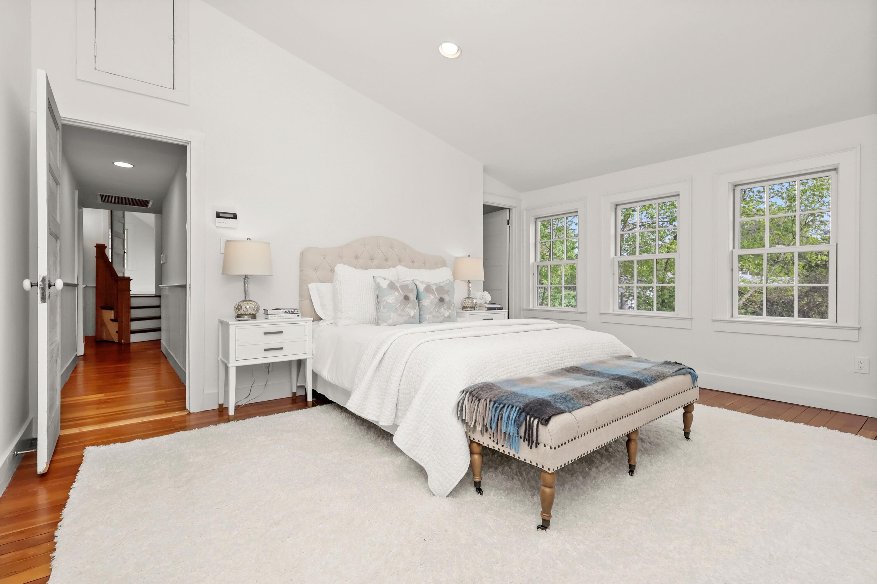 203 Brushy Ridge Road New Canaan, CT 06840 - Photo 25 of 42 a spacious bedroom with a bed and a large window