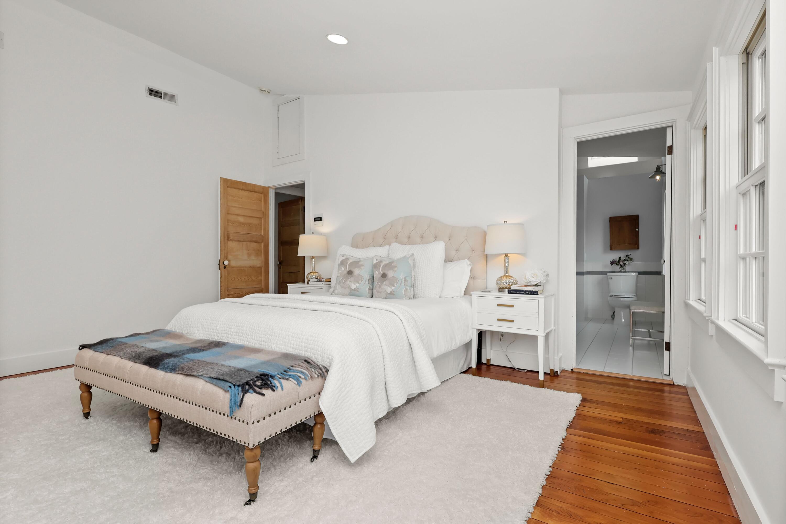 203 Brushy Ridge Road New Canaan, CT 06840 - Photo 26 of 42 a spacious bedroom with a bed and a table