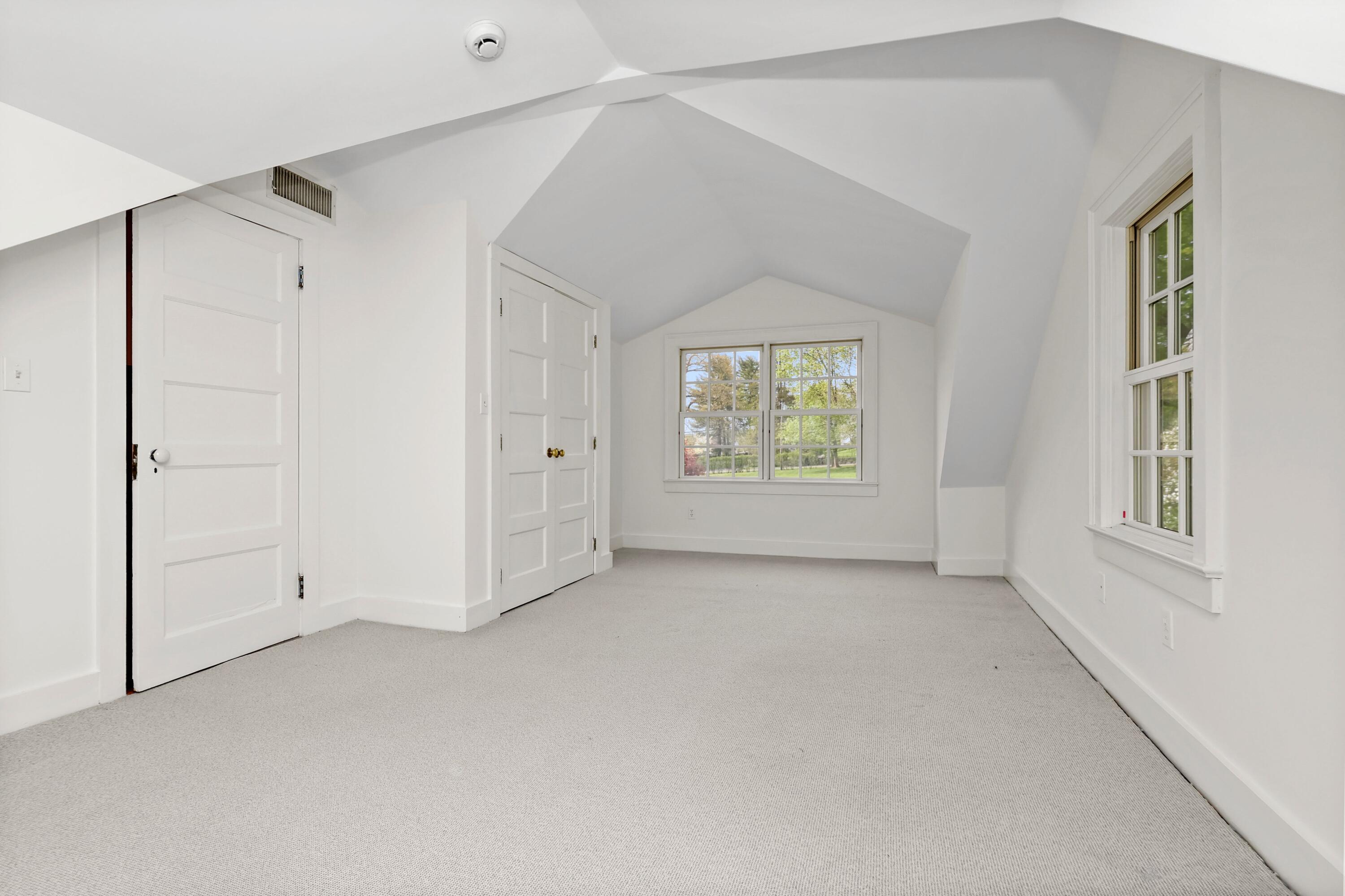 203 Brushy Ridge Road New Canaan, CT 06840 - Photo 29 of 42 an empty room with windows and closet