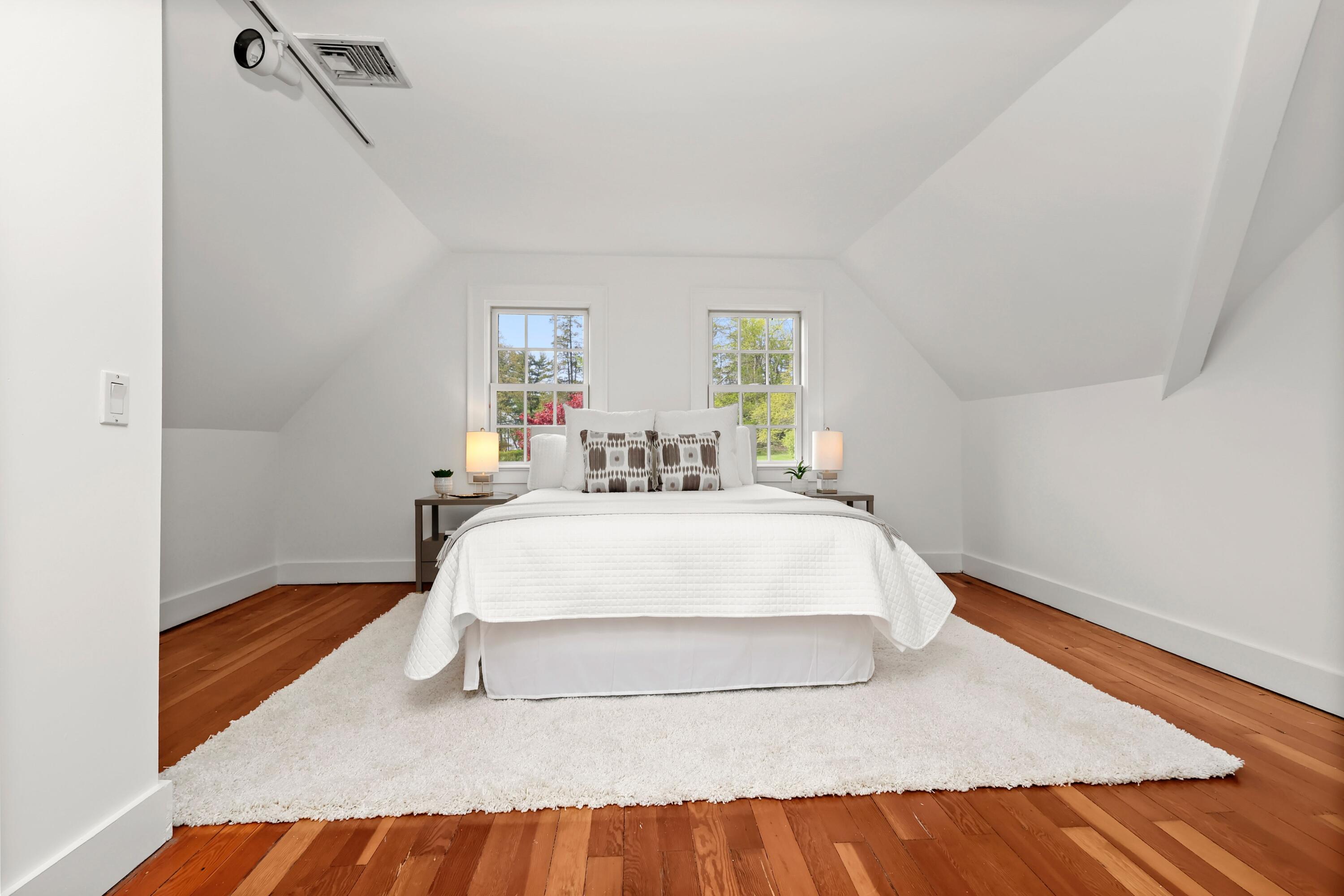 203 Brushy Ridge Road New Canaan, CT 06840 - Photo 31 of 42 a bed sitting in a bedroom next to a window