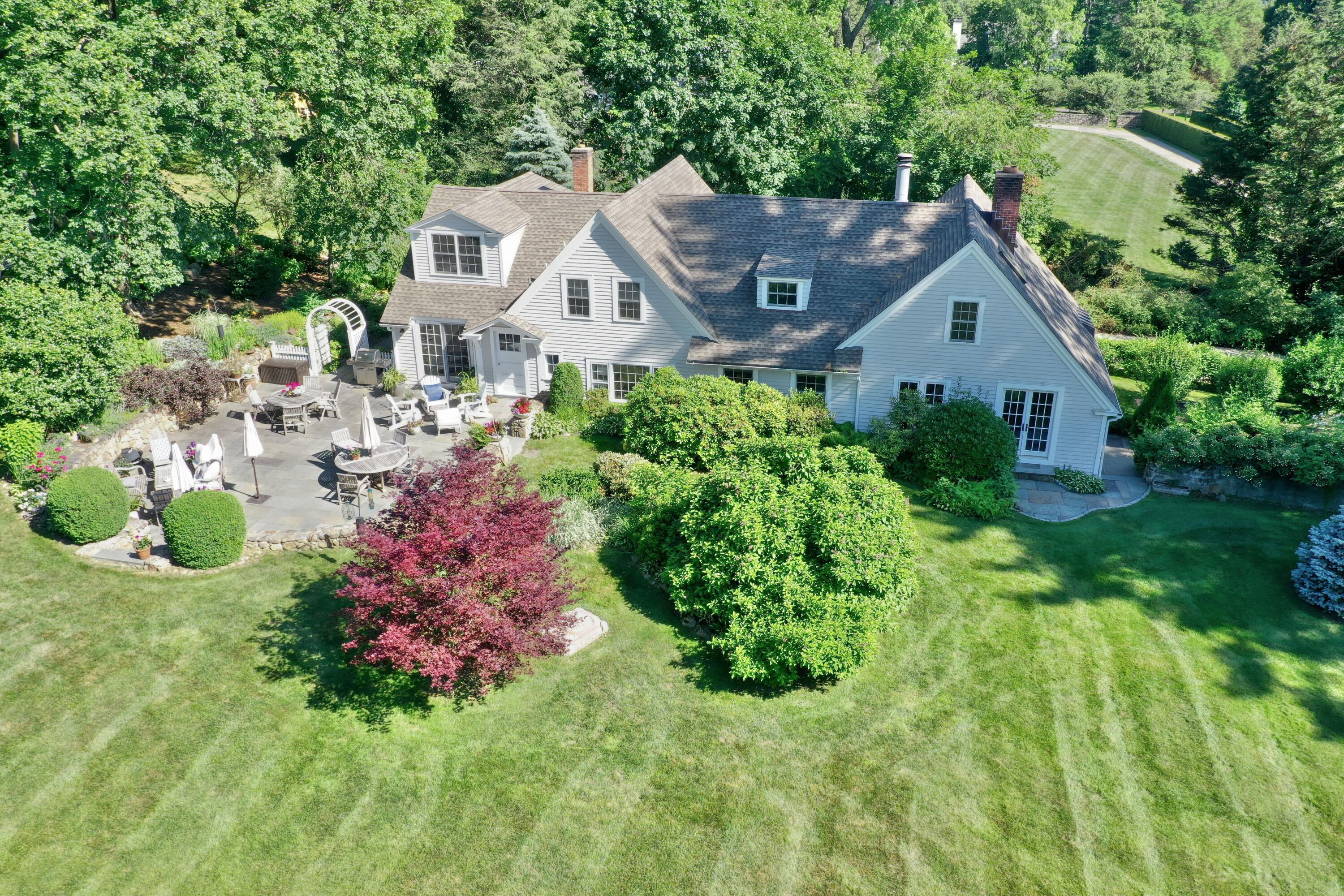 203 Brushy Ridge Road New Canaan, CT 06840 - Photo 4 of 42 a aerial view of a house with a yard and potted plants