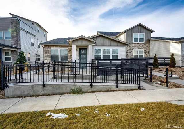 a front view of a house with iron fence