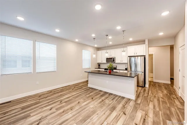 a view of kitchen with sink microwave and refrigerator
