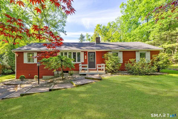 a house view with a sitting space and garden