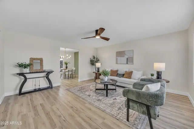 a living room with furniture and wooden floor