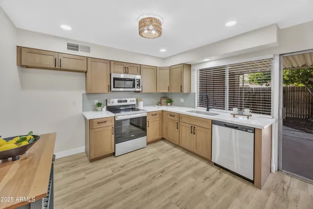 a kitchen with a stove a sink and a refrigerator