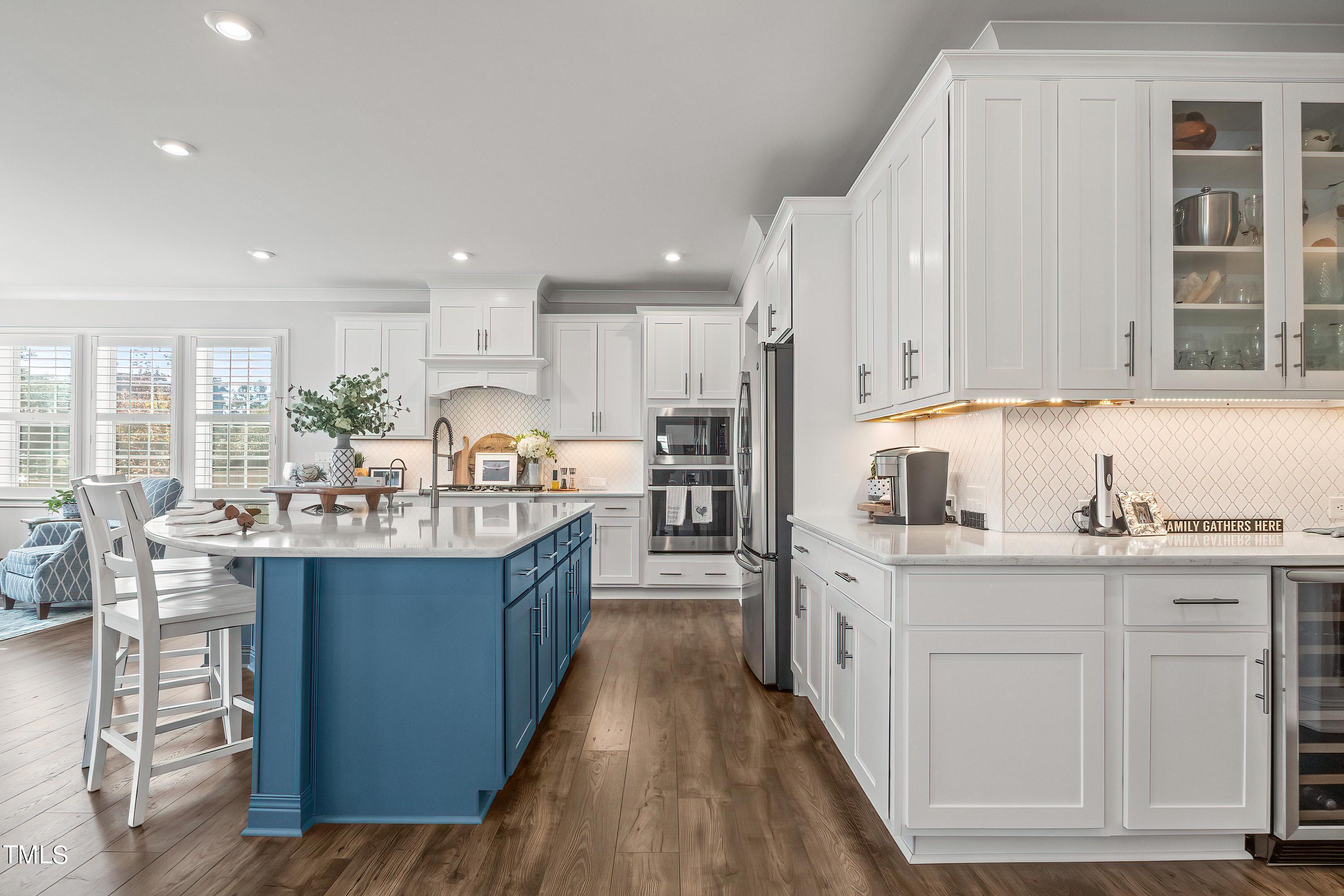 2025 Braeburn Drive Apex, NC 27539 - Photo 17 of 71 a kitchen with kitchen island granite countertop a sink and cabinets