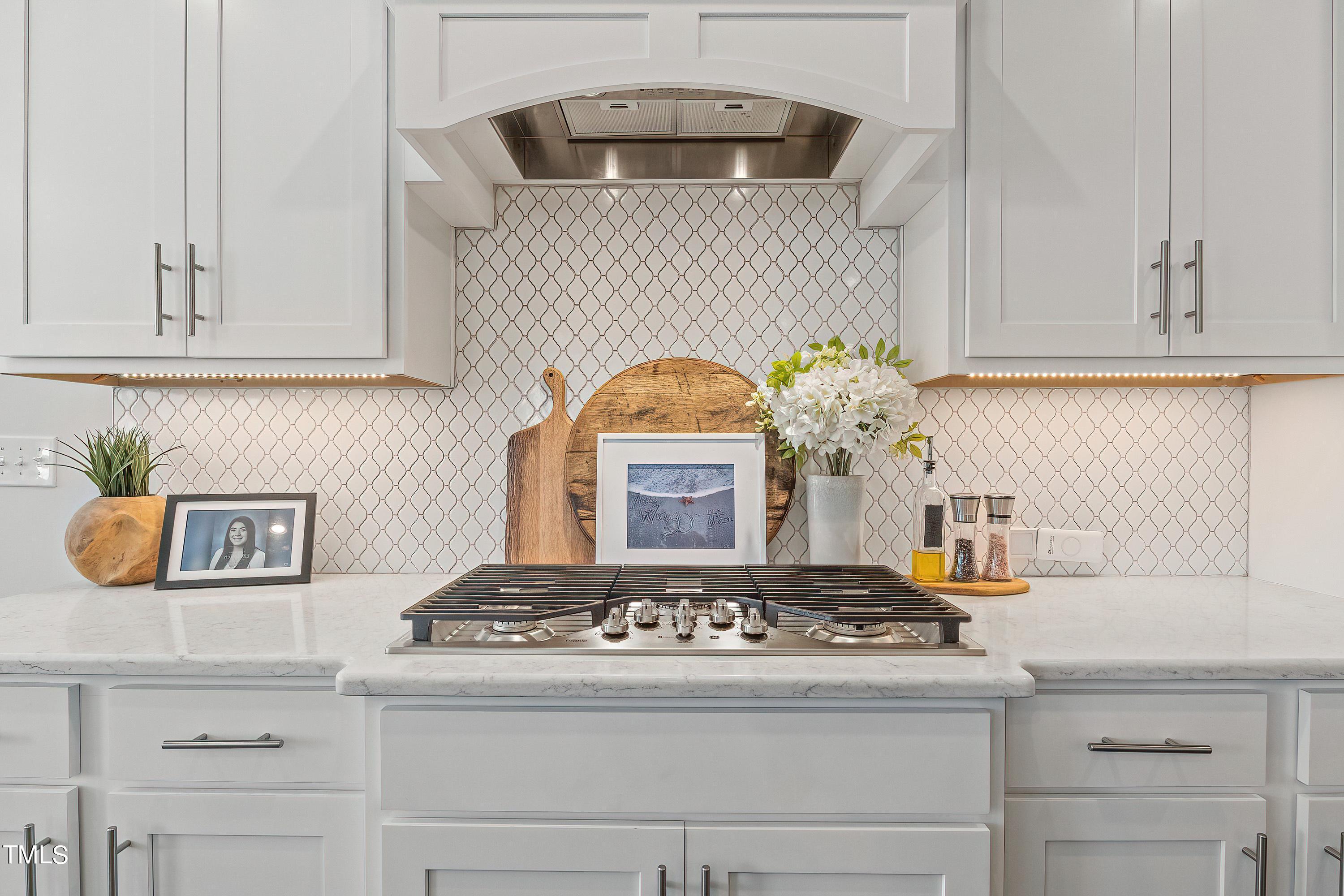 2025 Braeburn Drive Apex, NC 27539 - Photo 18 of 71 a kitchen with a stove and cabinets