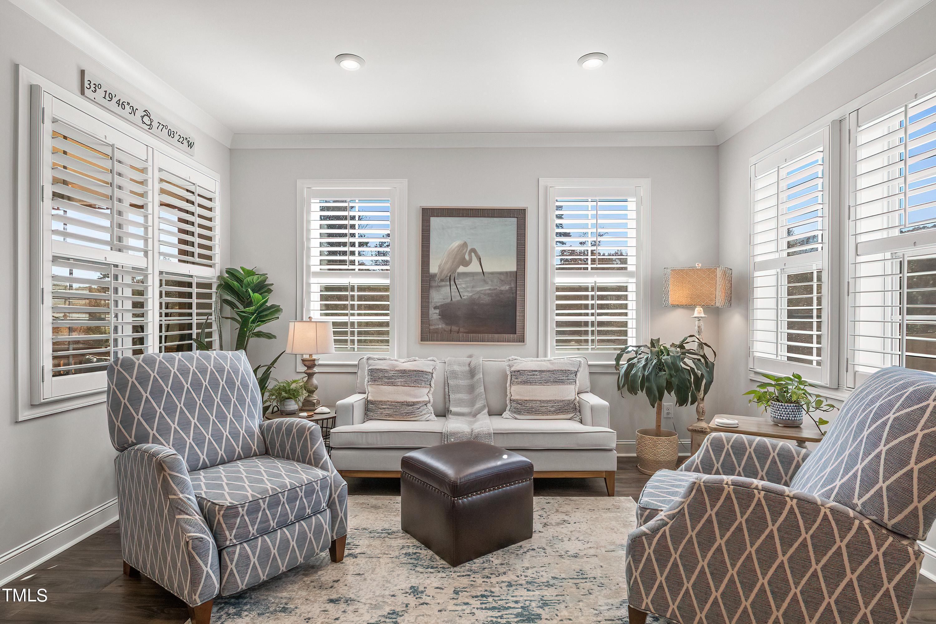 2025 Braeburn Drive Apex, NC 27539 - Photo 25 of 71 a living room with furniture and a large window