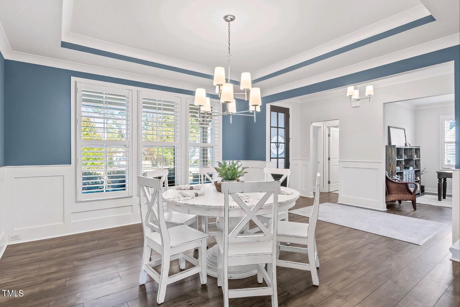 2025 Braeburn Drive Apex, NC 27539 - Photo 26 of 71 a view of a dining room with furniture window and wooden floor