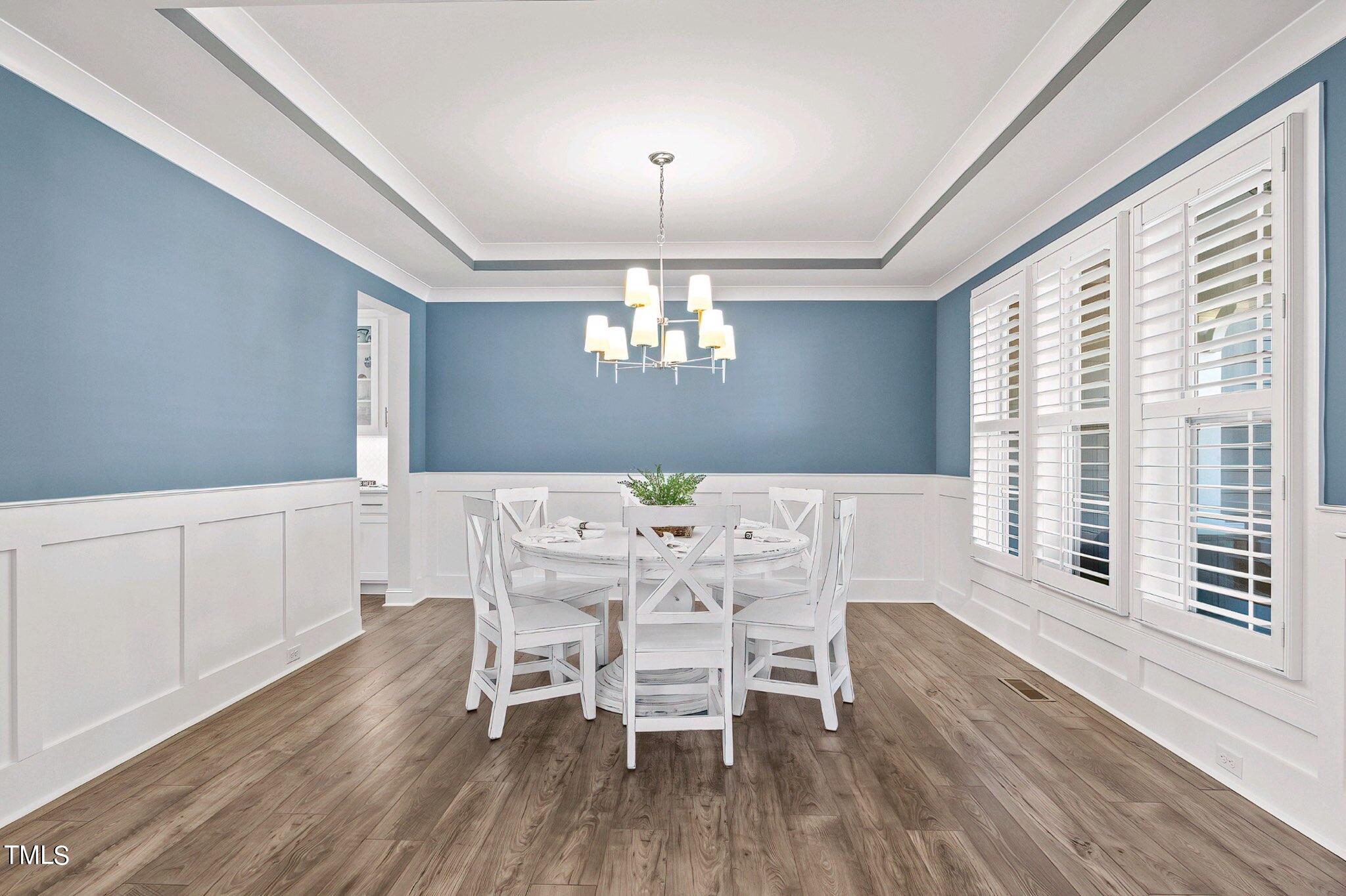 2025 Braeburn Drive Apex, NC 27539 - Photo 27 of 71 a view of a dining room with furniture window and wooden floor