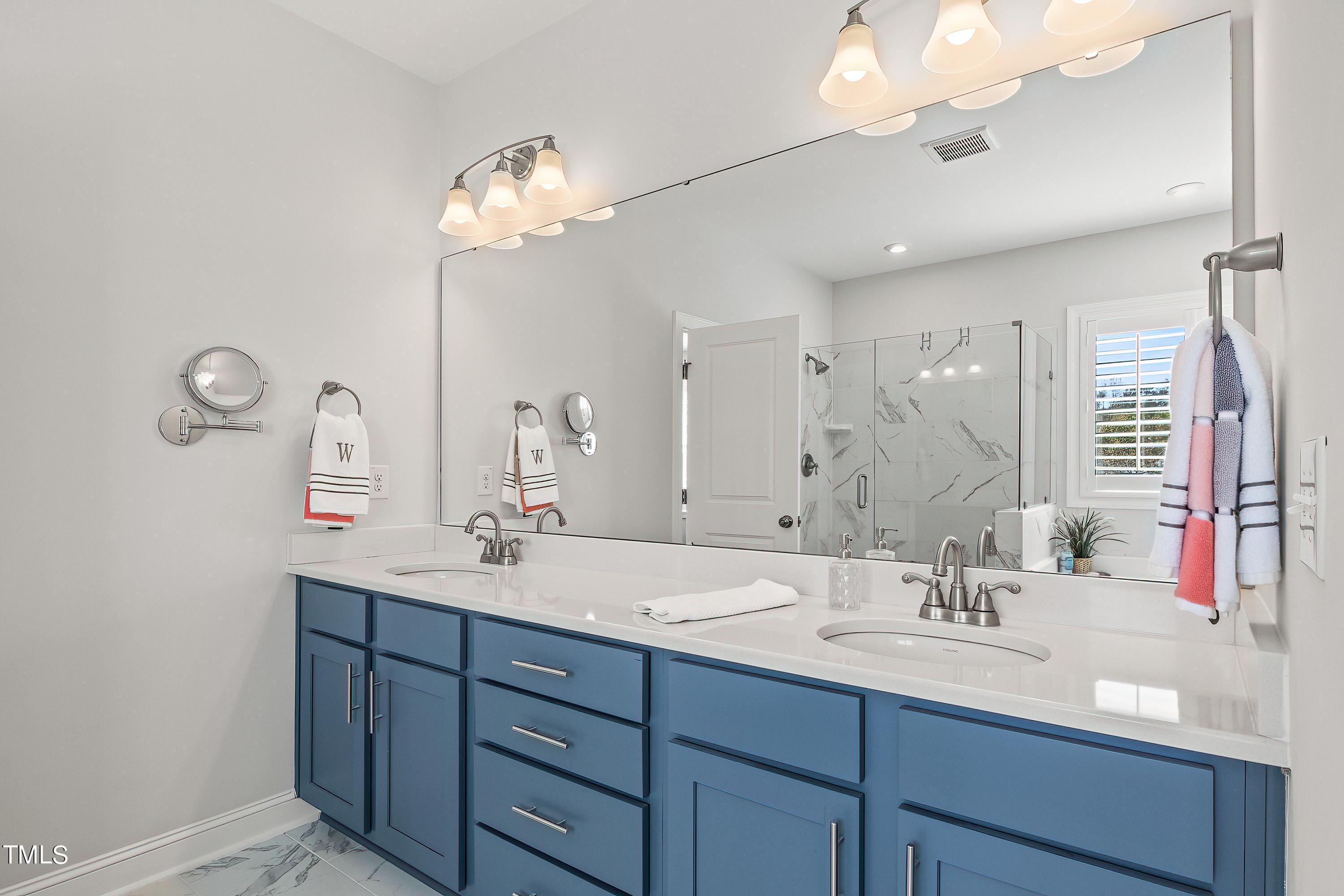 2025 Braeburn Drive Apex, NC 27539 - Photo 36 of 71 a bathroom with a double vanity sink and a mirror