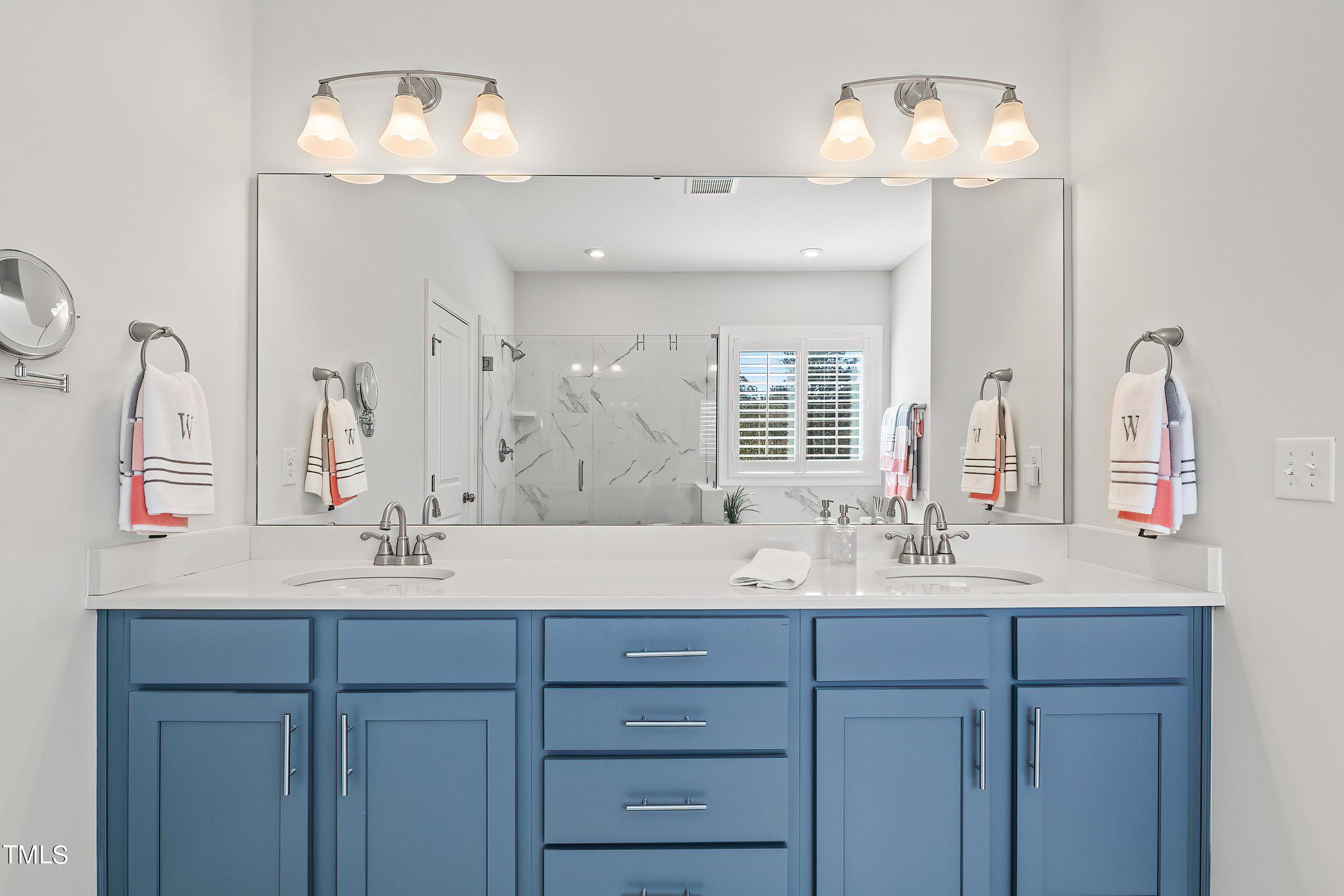 2025 Braeburn Drive Apex, NC 27539 - Photo 37 of 71 a bathroom with a sink double vanity and a mirror