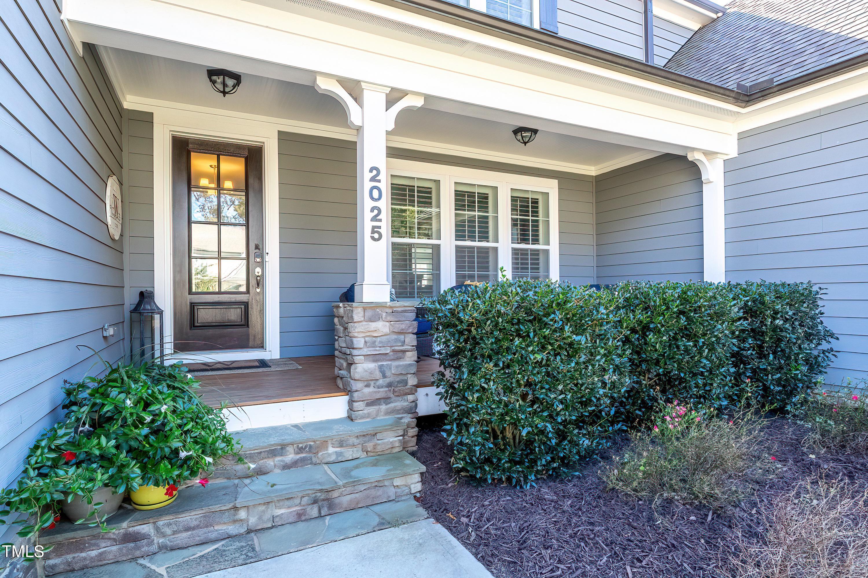 2025 Braeburn Drive Apex, NC 27539 - Photo 4 of 71 a front view of a house with garden