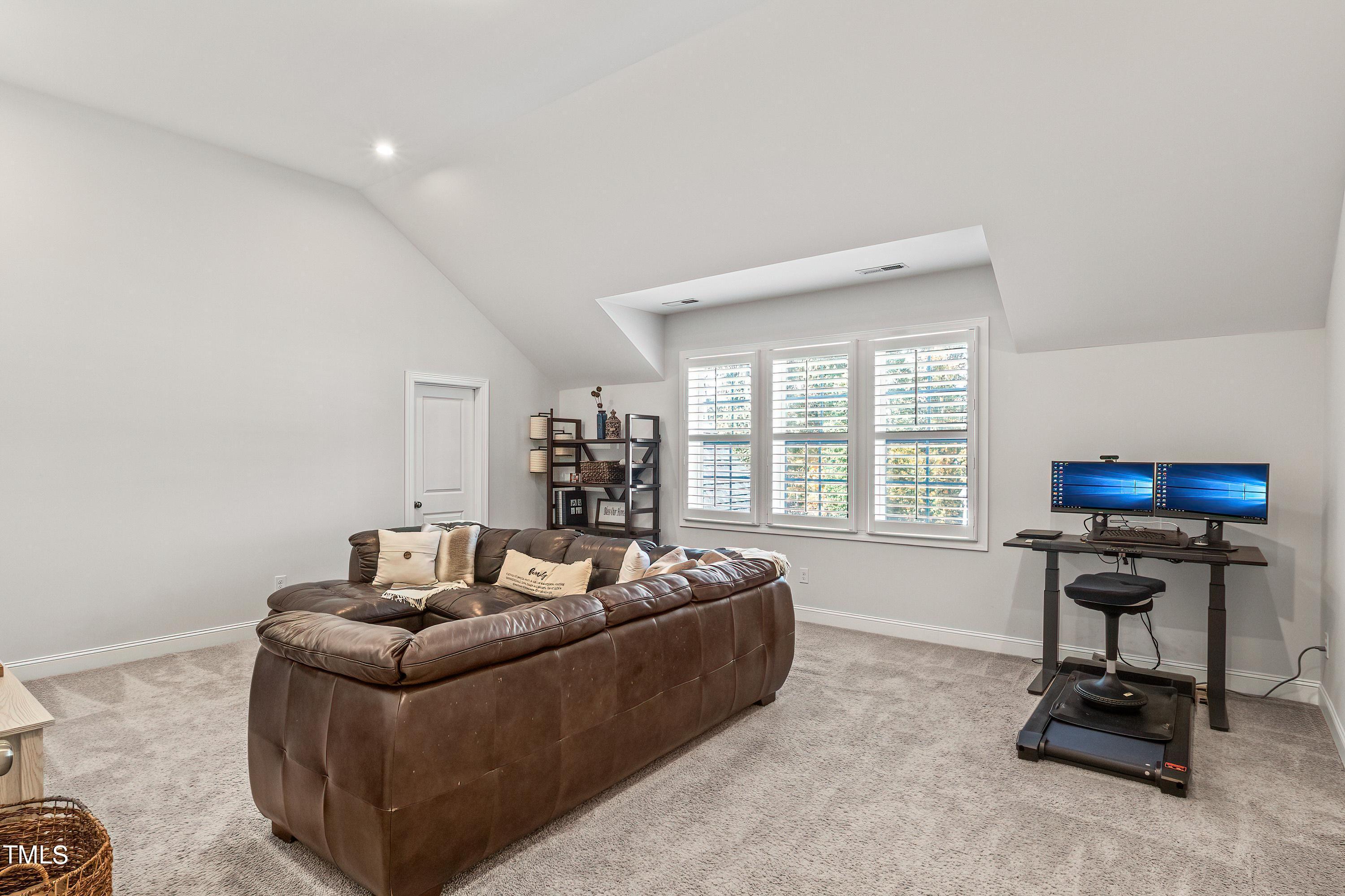 2025 Braeburn Drive Apex, NC 27539 - Photo 42 of 71 a living room with furniture and a window