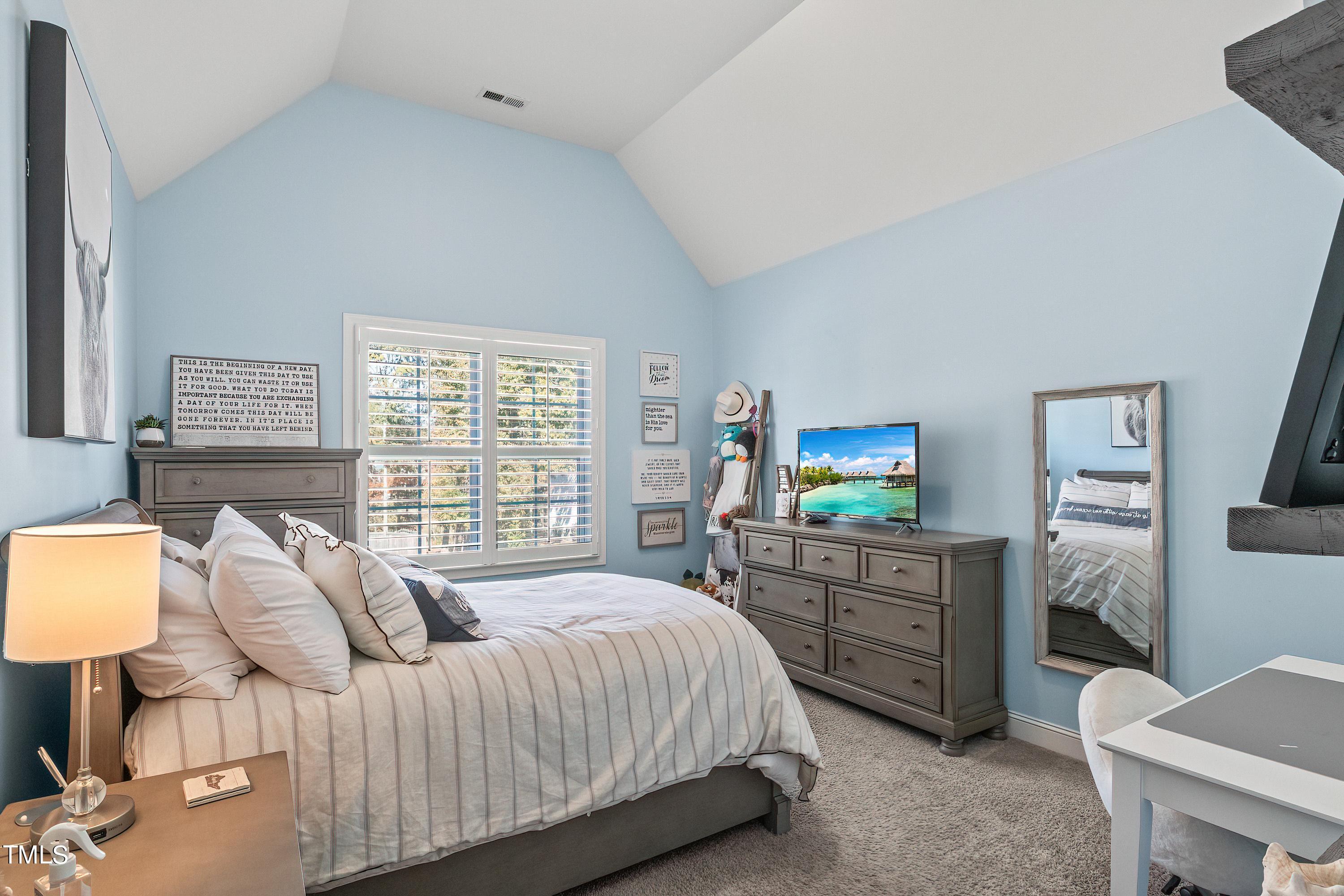 2025 Braeburn Drive Apex, NC 27539 - Photo 43 of 71 a bedroom with a bed and furniture