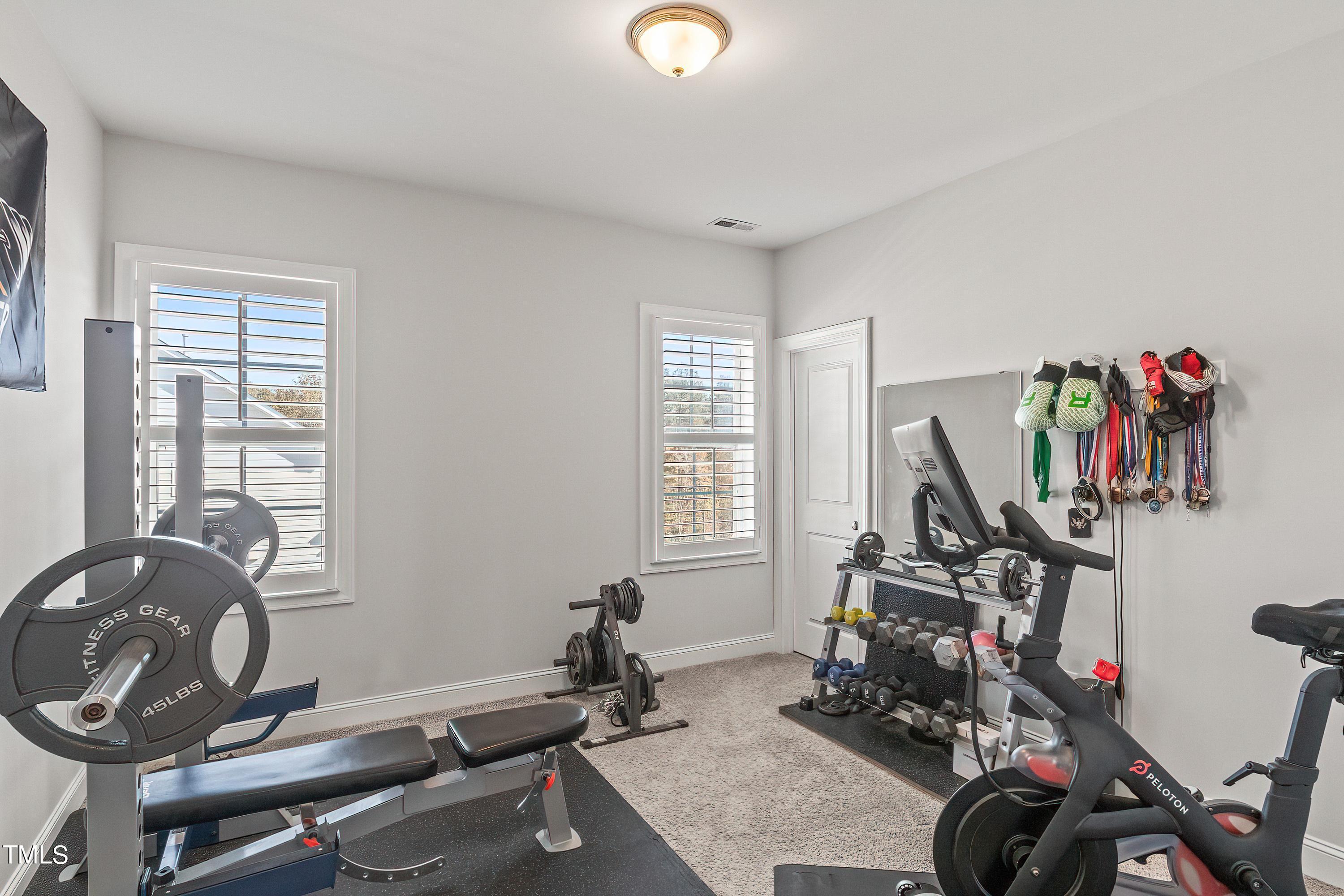2025 Braeburn Drive Apex, NC 27539 - Photo 48 of 71 a view of a room with gym equipment